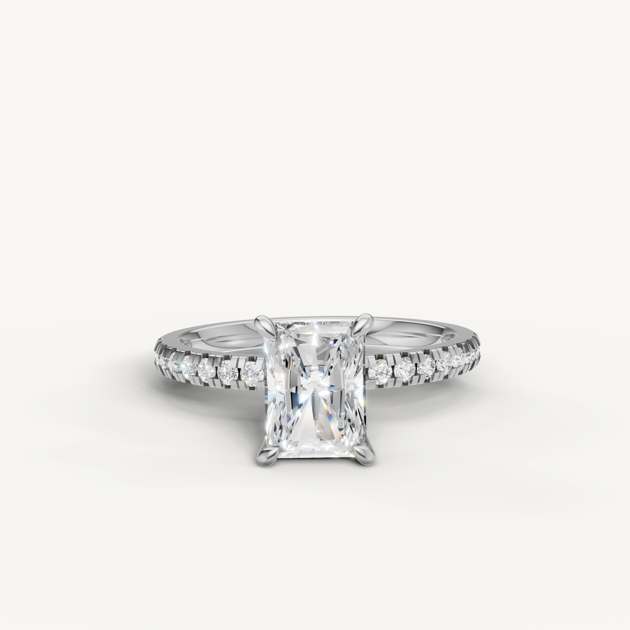 Modern white gold radiant cut diamond engagement ring with a seamless pavé band and exceptional light return.