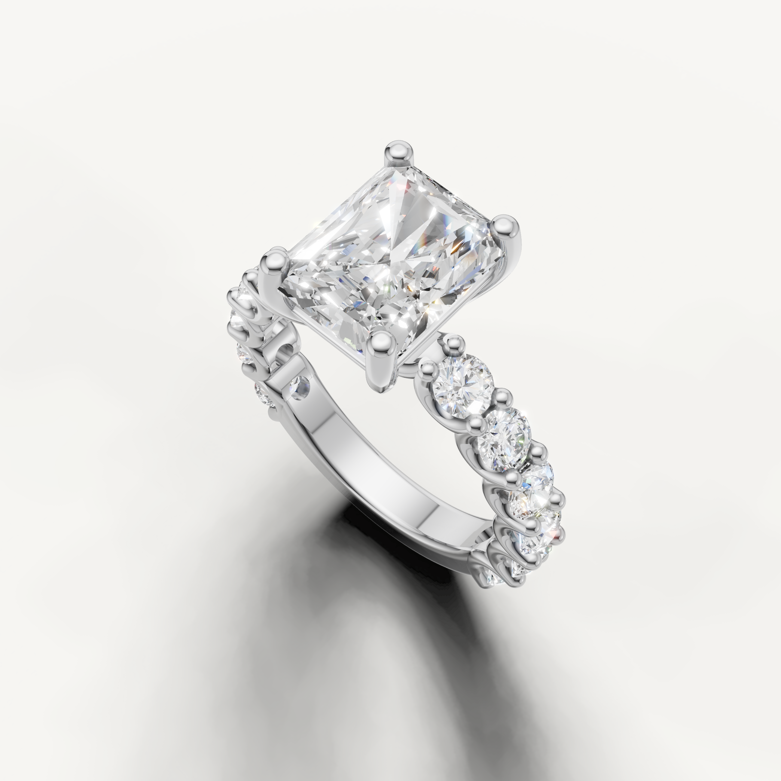 Radiant diamond engagement ring with open gallery and shared prong band white gold side angle