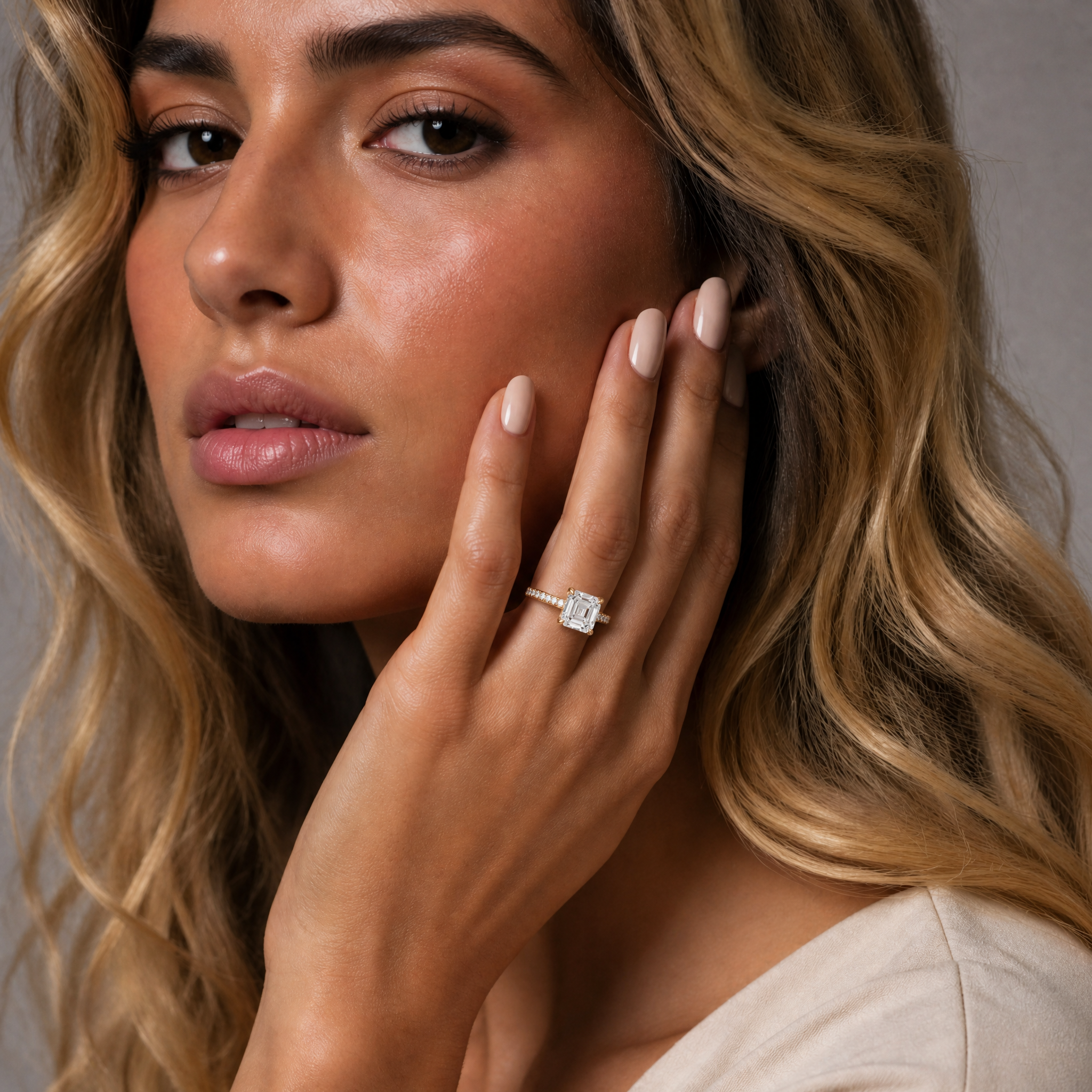 Model wearing Raul Diamonds asscher cut lab grown diamond engagement ring in 14K yellow gold with pavé band and vintage-inspired solitaire setting