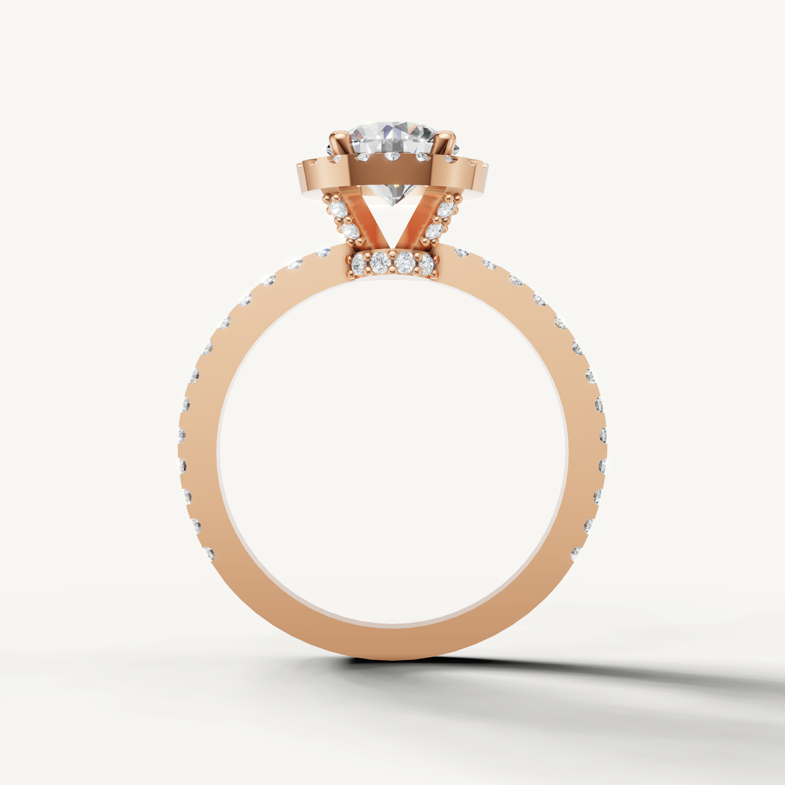 Rose gold engagement ring with round center diamond and halo setting.