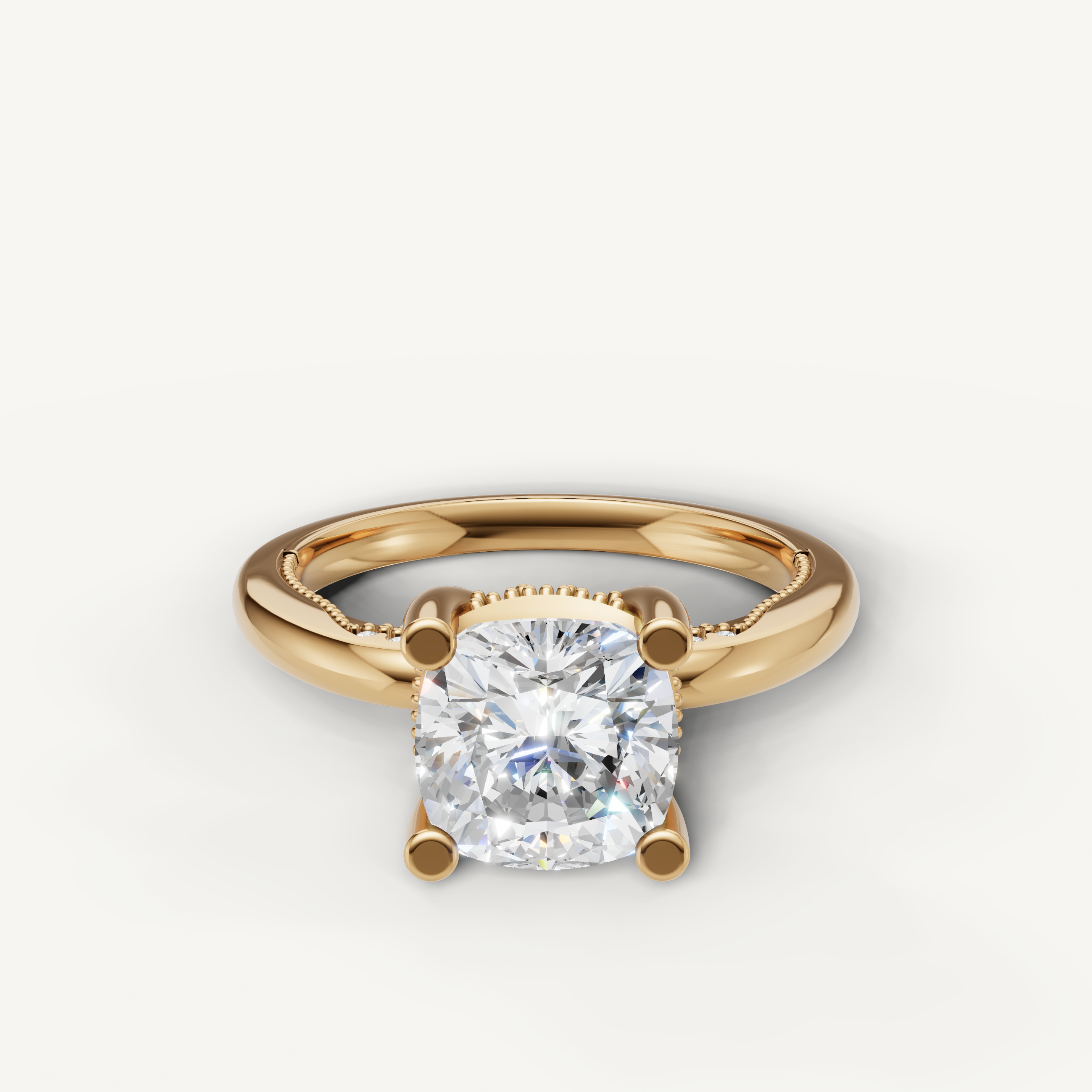A classic solitaire ring in 14k yellow gold featuring a brilliant cushion-cut diamond set in a polished four-prong setting.