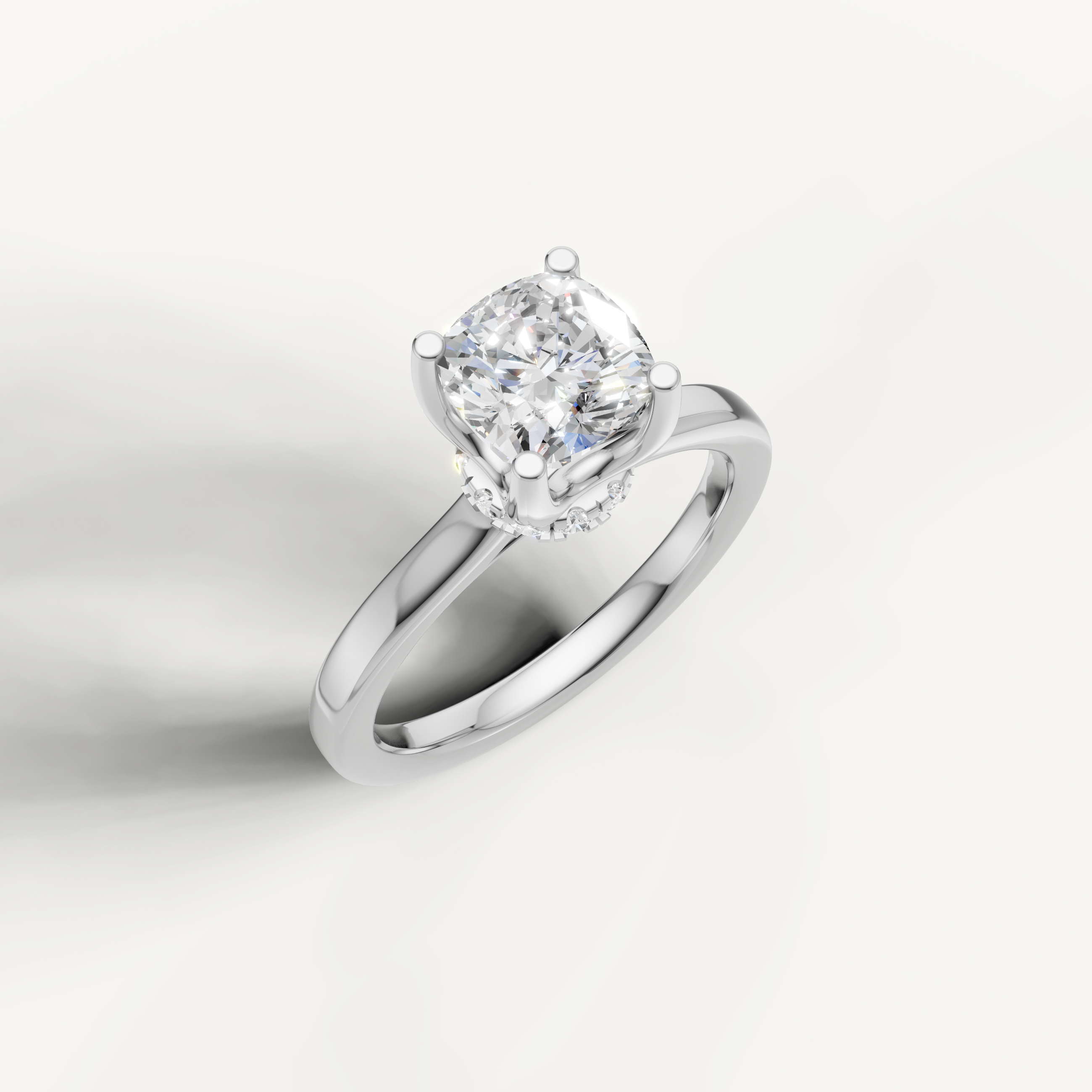 A bright, silvery-white engagement ring showcasing a prominent cushion-cut center stone on a smooth, high-polish band.