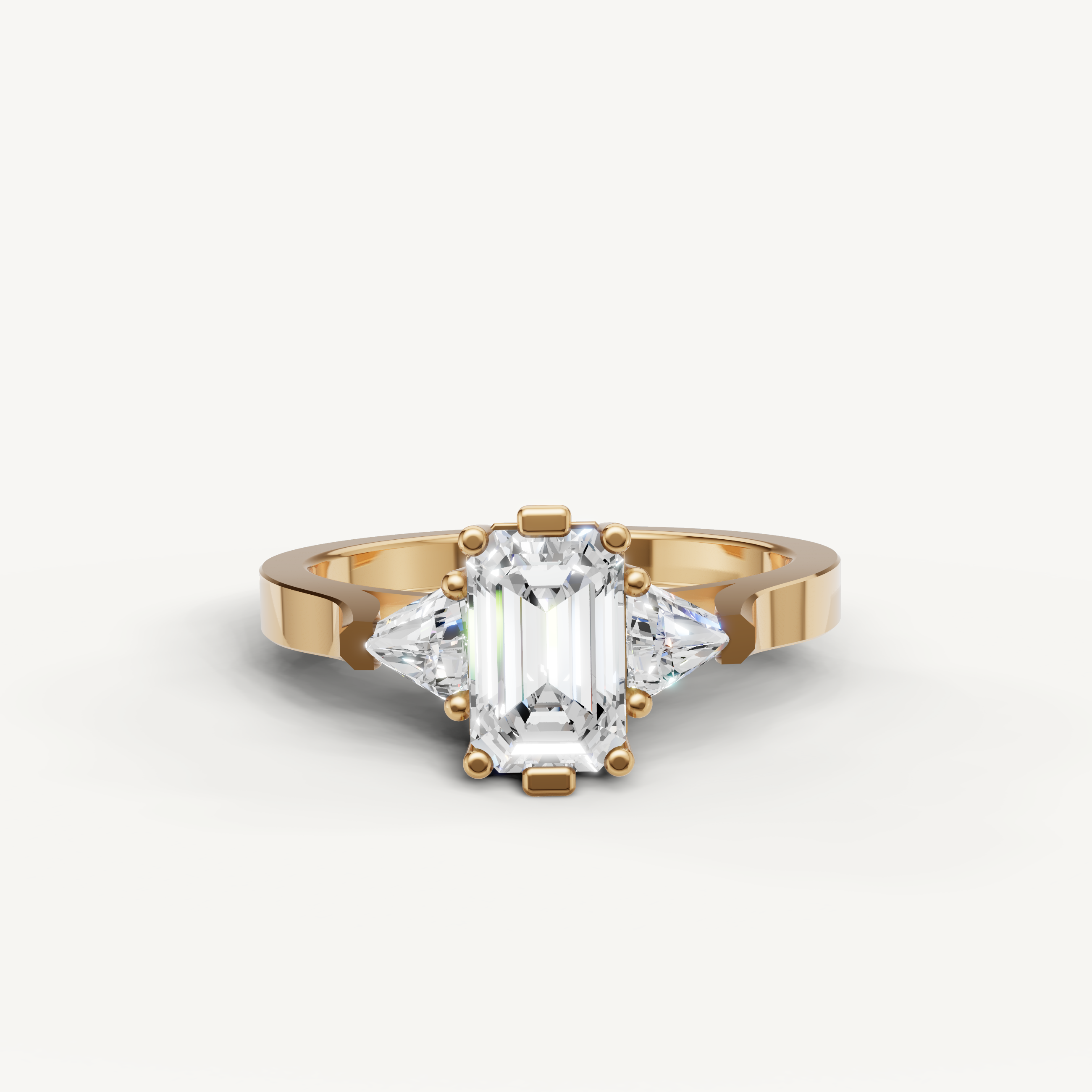 Raul Diamonds emerald cut engagement ring with trapezoid side diamonds in yellow gold.