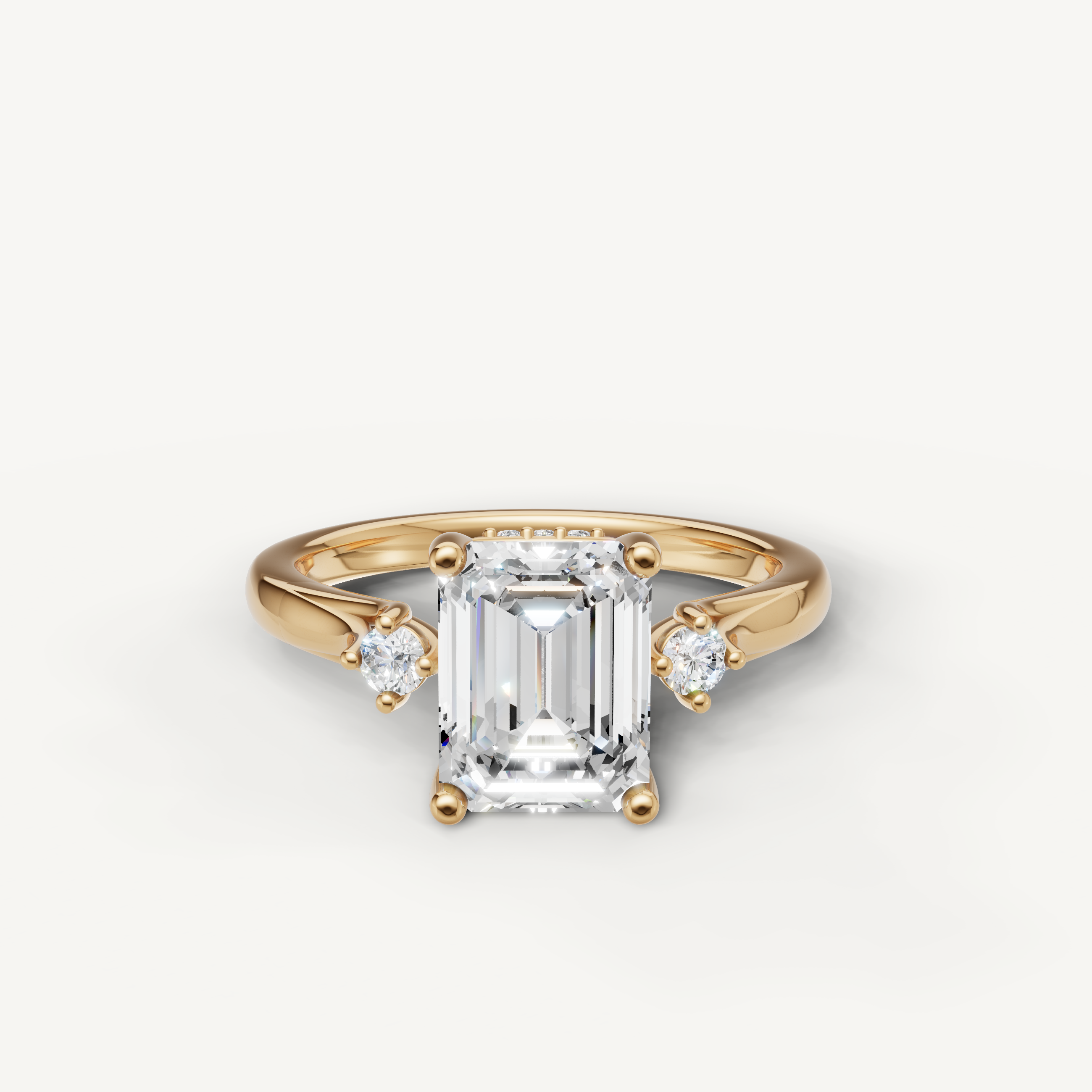 Emerald cut lab grown diamond engagement ring in 14K yellow gold with round side stones by Raul Diamonds