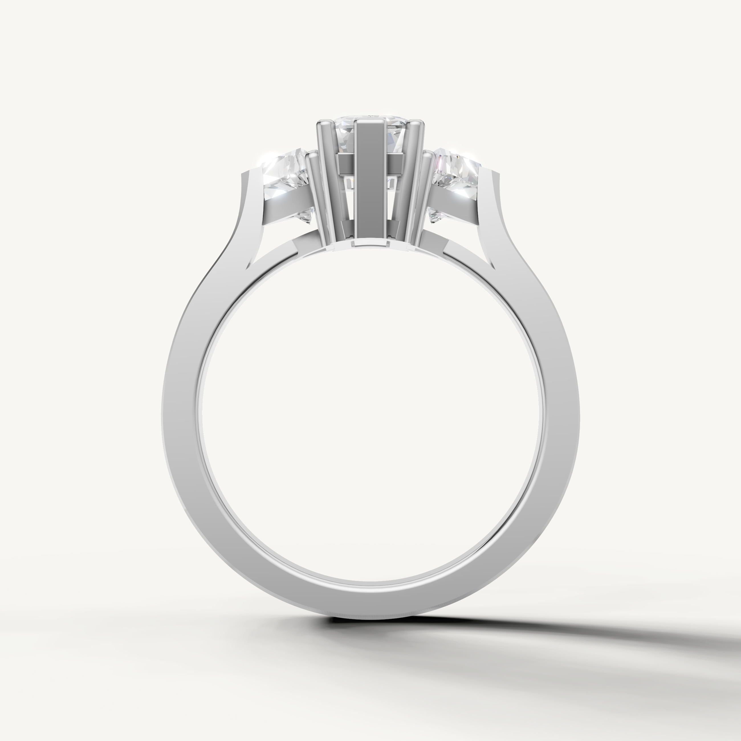 White gold emerald cut three stone ring with sophisticated diamond detailing by Raul Diamonds.