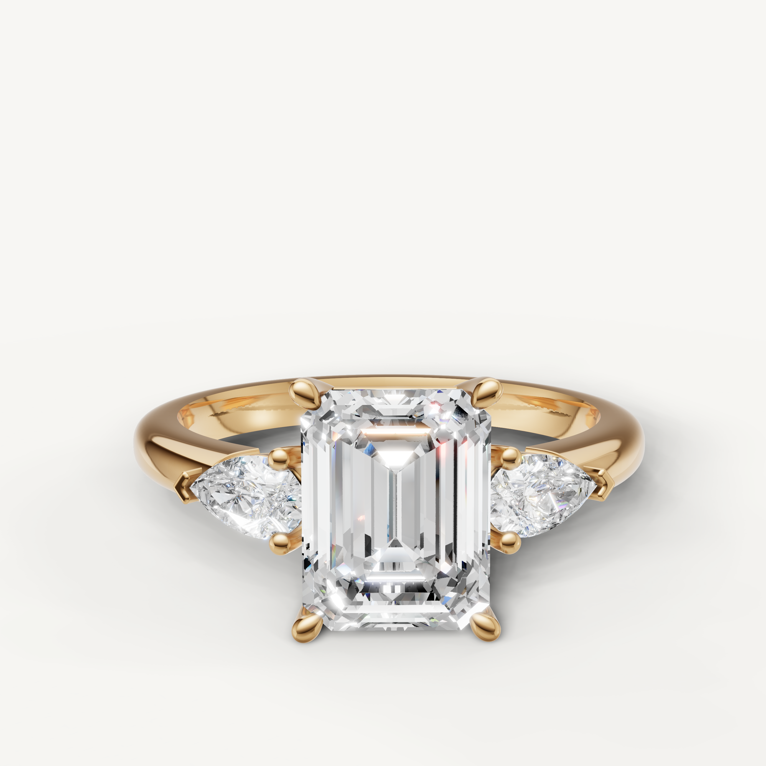 emerald cut lab grown diamond engagement ring with marquise side stones yellow gold