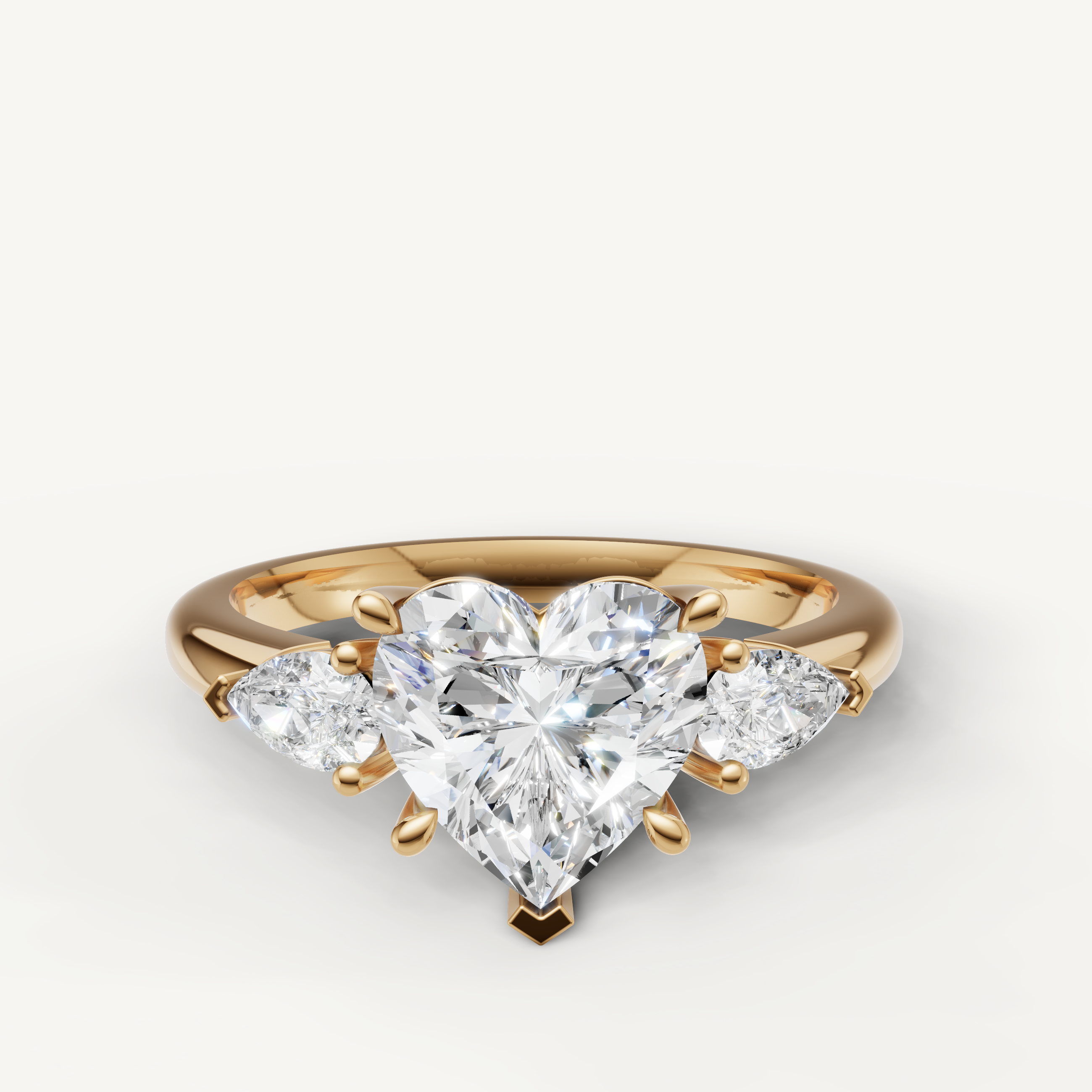 heart cut lab grown diamond engagement ring with pear side stones yellow gold