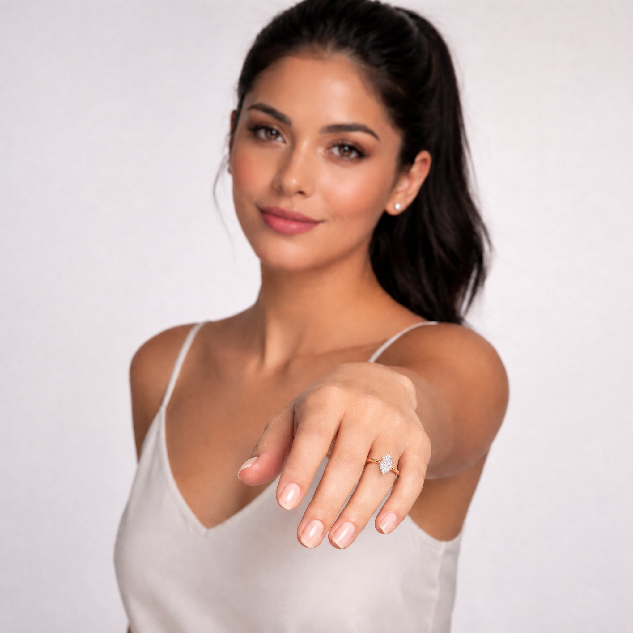 Sophisticated model Isabella showcasing a Raul Diamonds marquise cut engagement ring, highlighting the finger-elongating silhouette and brilliant hidden halo collar.