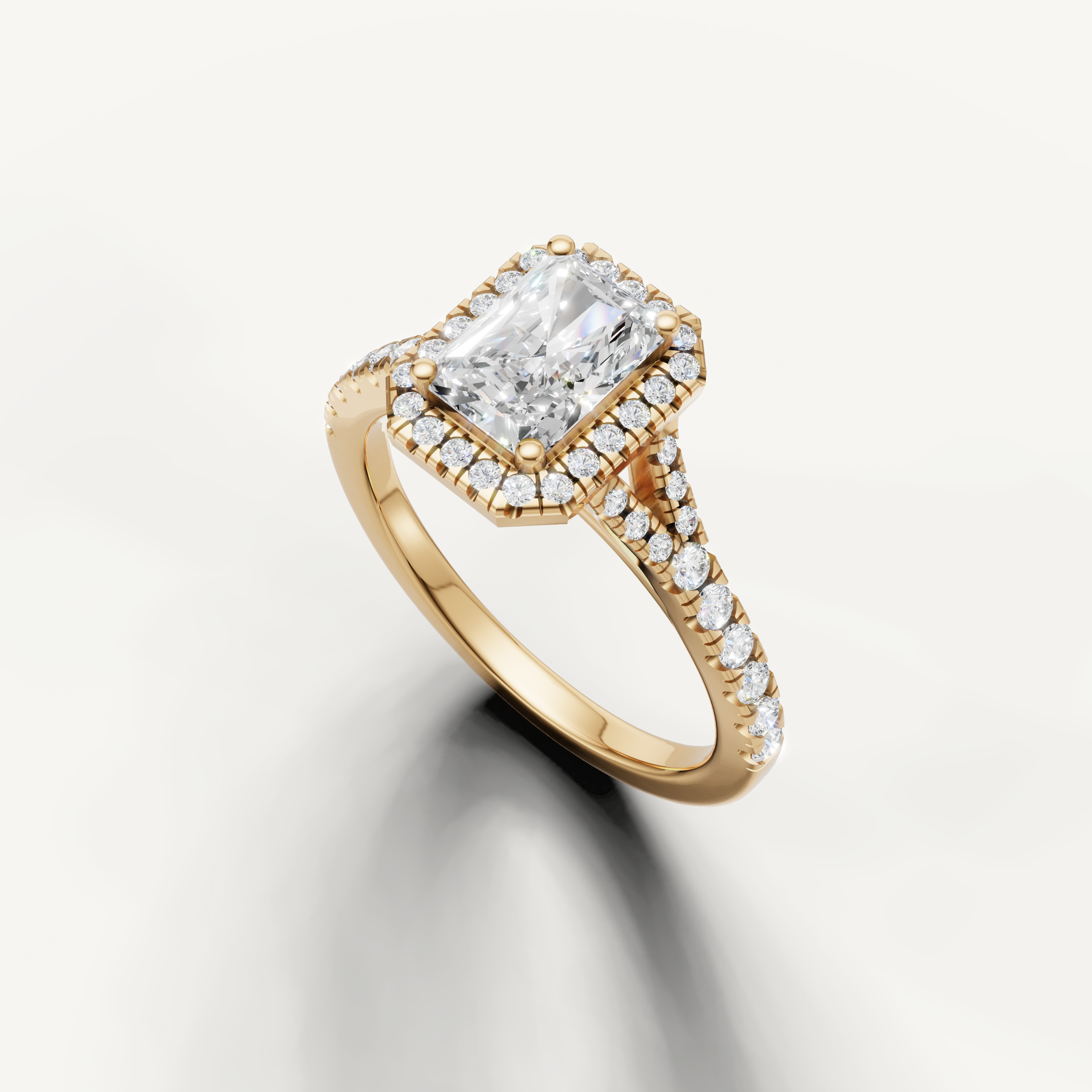 Rectangular radiant diamond halo ring with split pavé band yellow gold