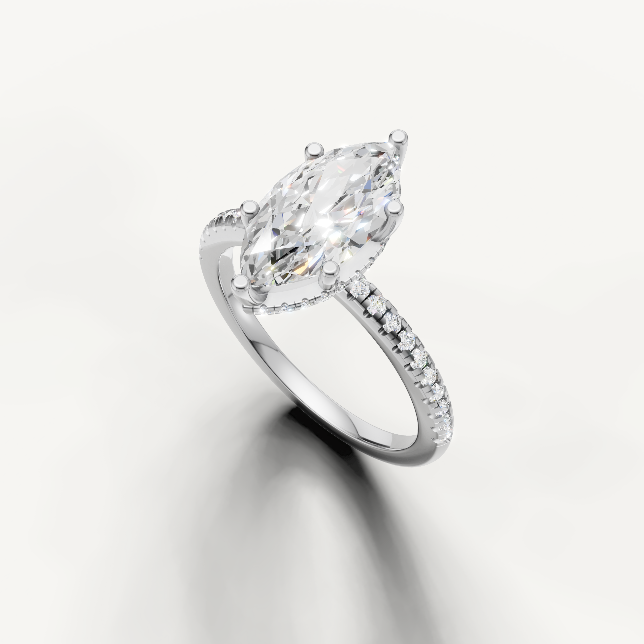 elongated marquise diamond engagement ring with delicate pavé setting in white gold