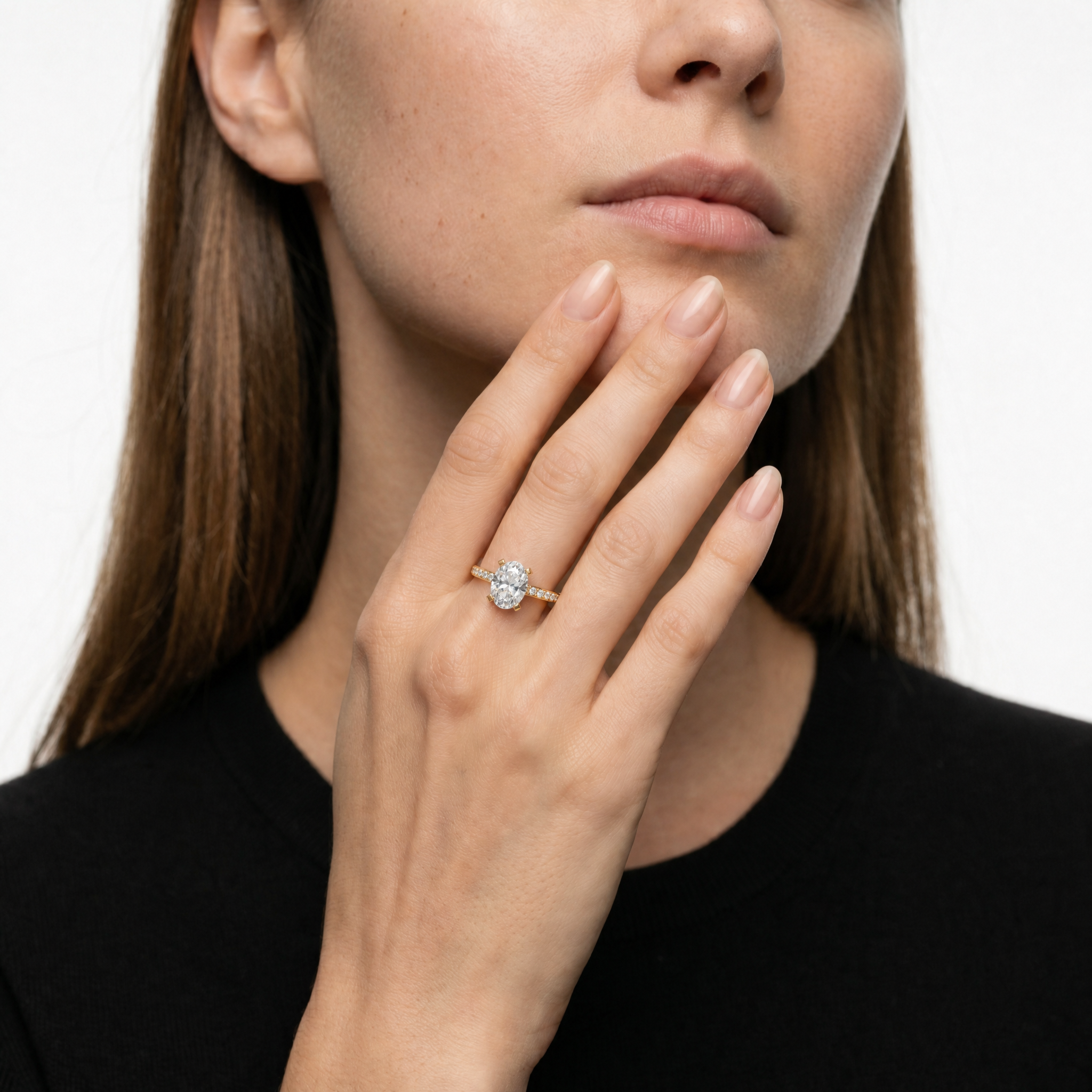 Model wearing an oval cut lab grown diamond pavé engagement ring in 14K gold by Raul Diamonds