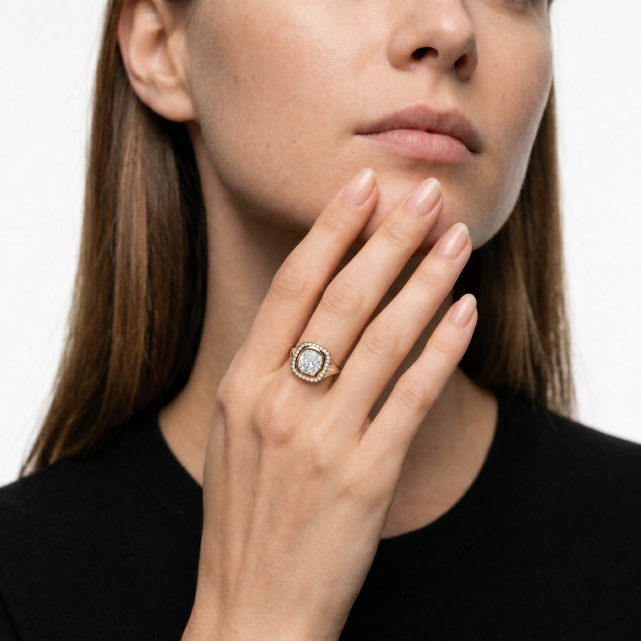 Model wearing Raul Diamonds pear diamond halo engagement ring in yellow gold with luxury bridal styling.