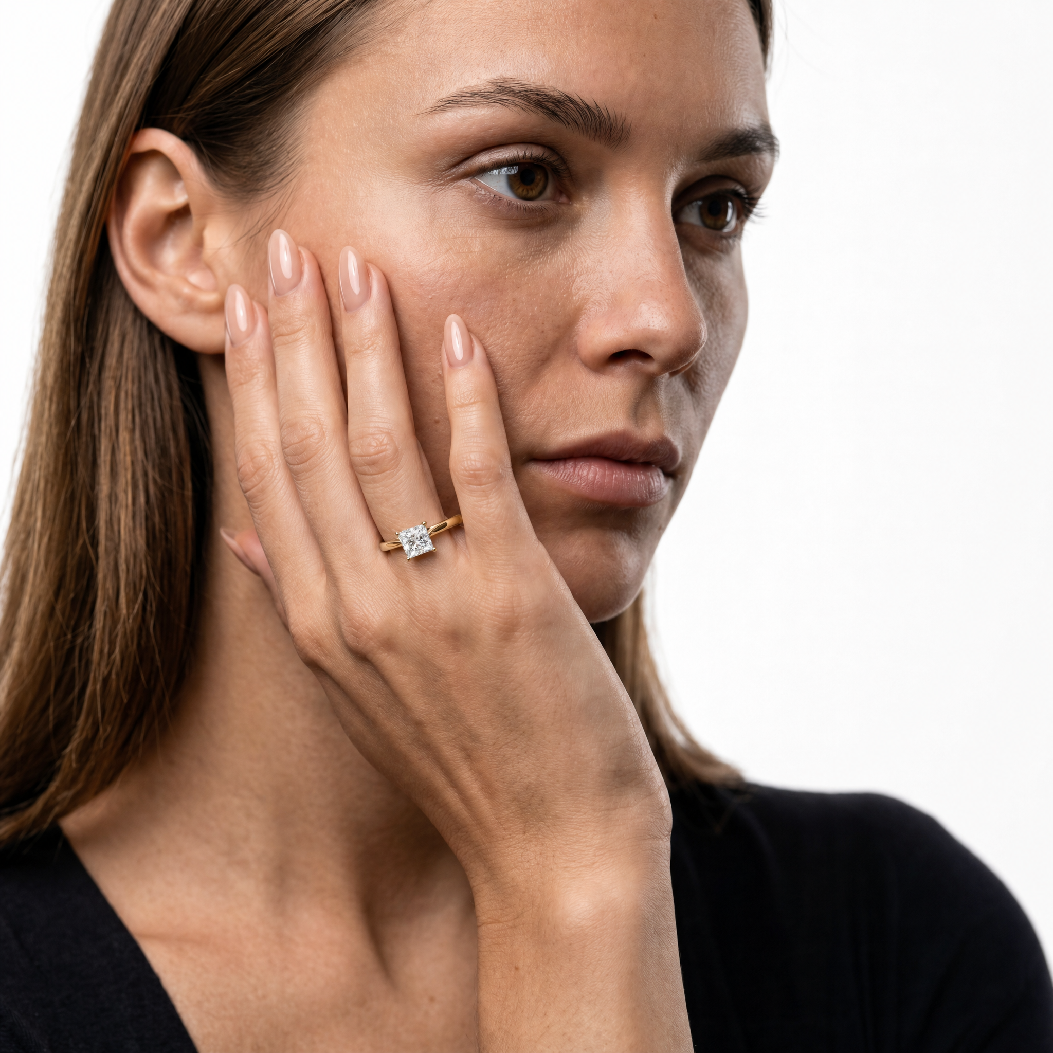 Elegant model wearing a princess-cut lab-grown diamond engagement ring with hidden halo in 14K gold by Raul Diamonds