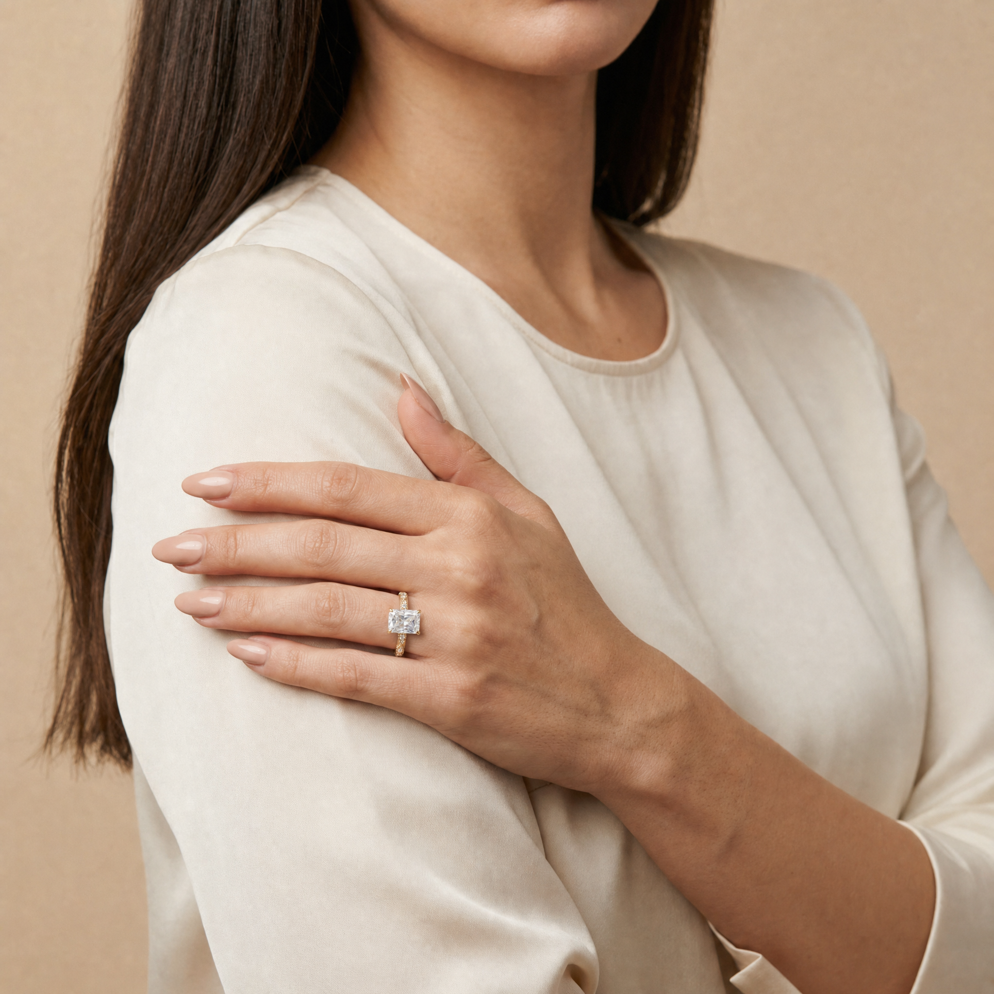 Model wearing Raul Diamonds radiant cut lab grown diamond engagement ring in 14K gold with elegant twisted pavé band
