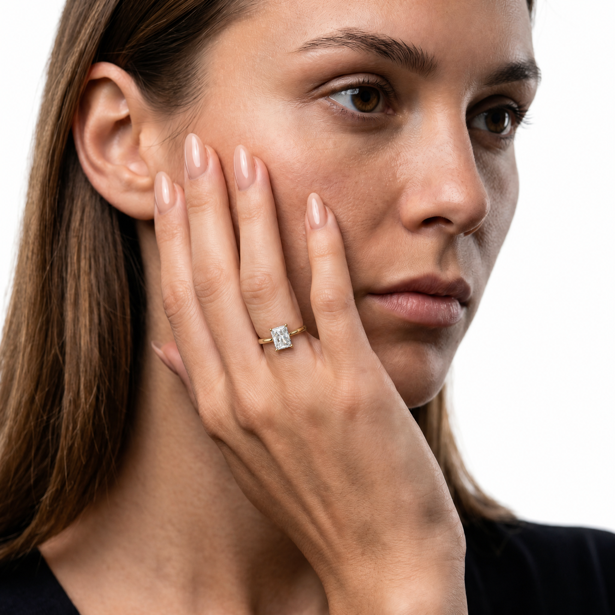 Elegant model wearing a radiant-cut lab-grown diamond engagement ring with hidden halo in 14K gold by Raul Diamonds
