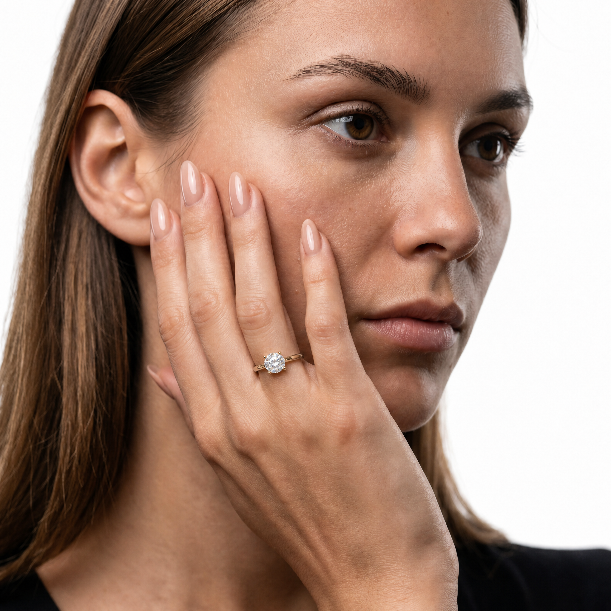 Elegant model wearing a round brilliant lab-grown diamond engagement ring with hidden halo in 14K gold by Raul Diamonds