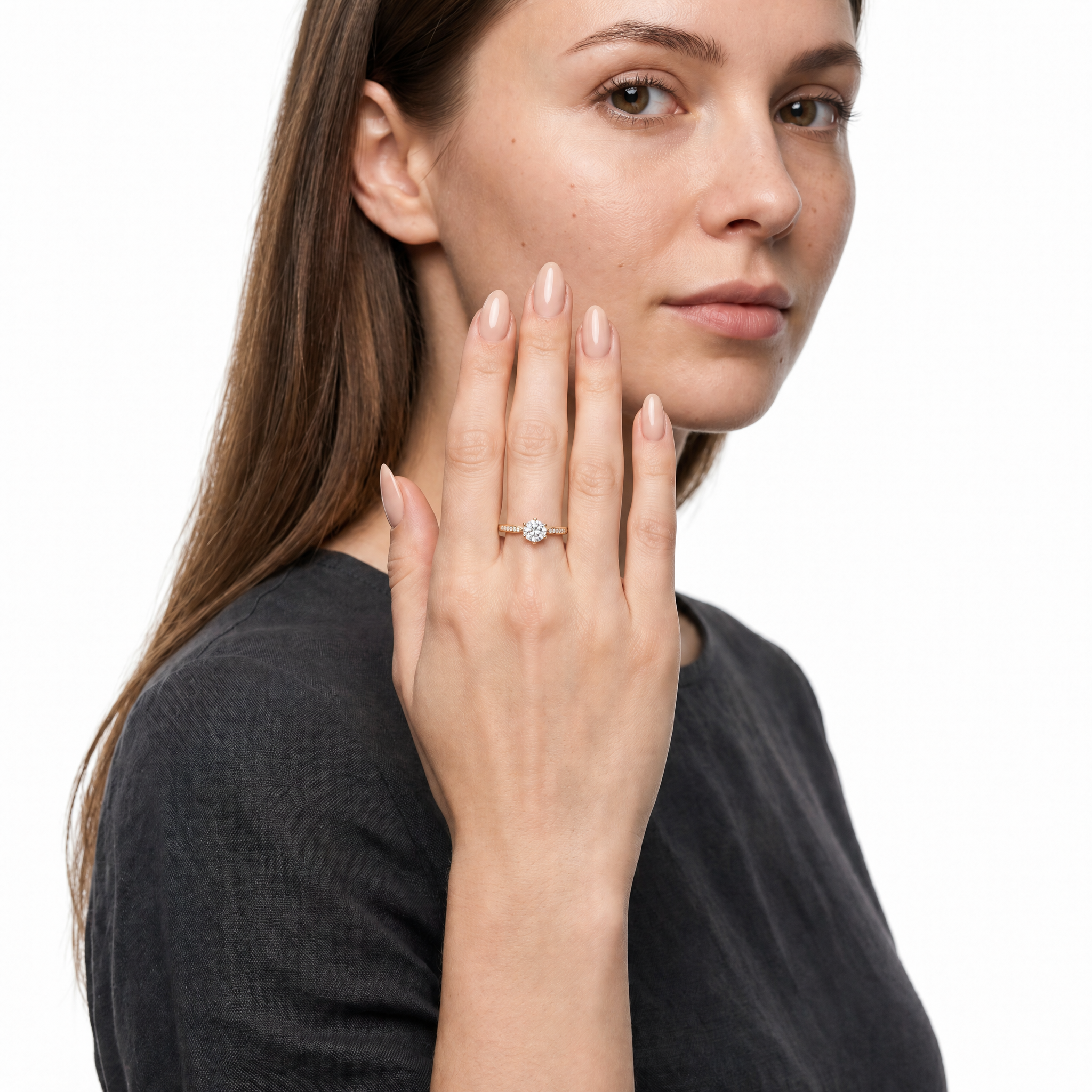 Model wearing Raul Diamonds round solitaire diamond engagement ring in yellow gold with pavé diamond band