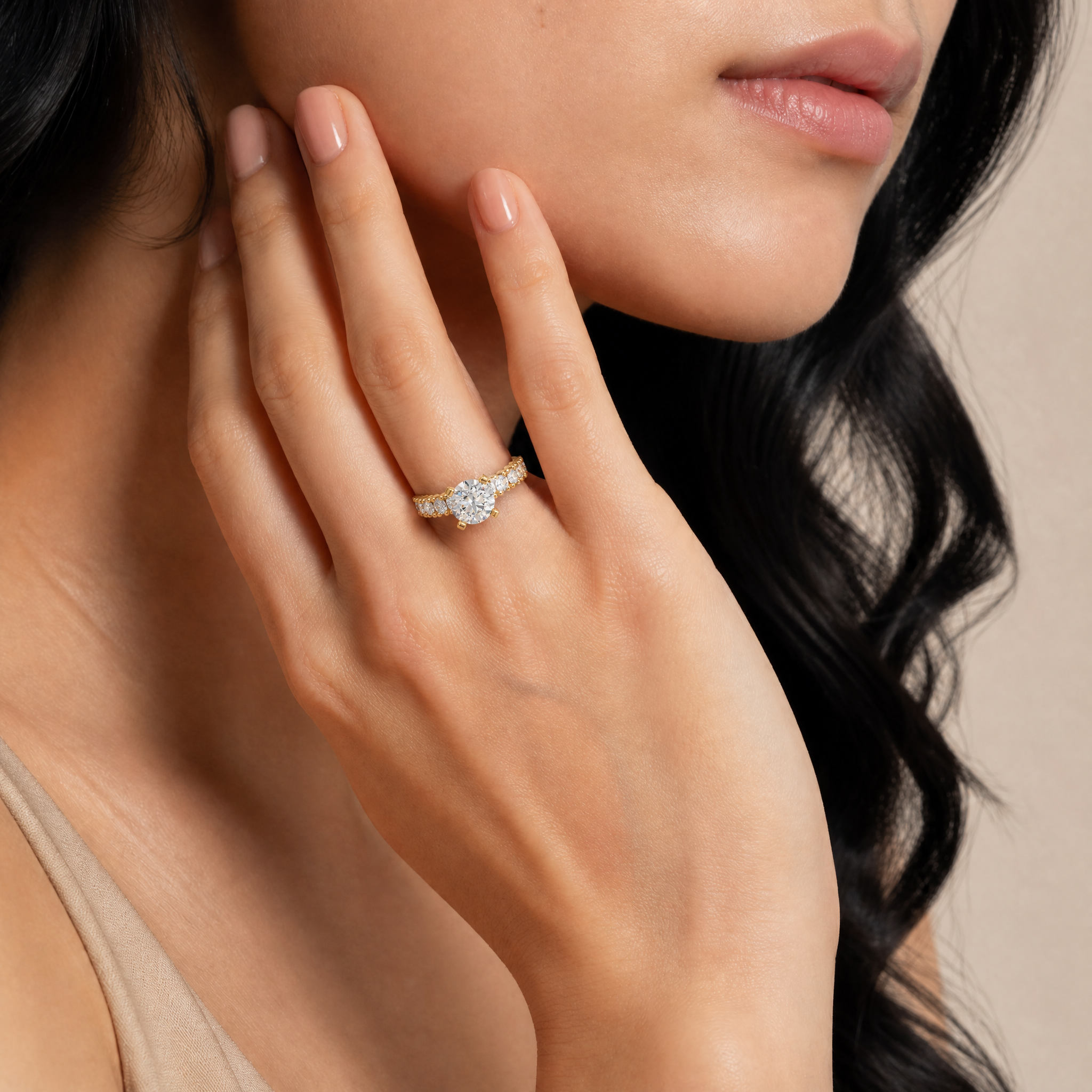 Model wearing Raul Diamonds round vintage diamond engagement ring in yellow gold with side diamonds