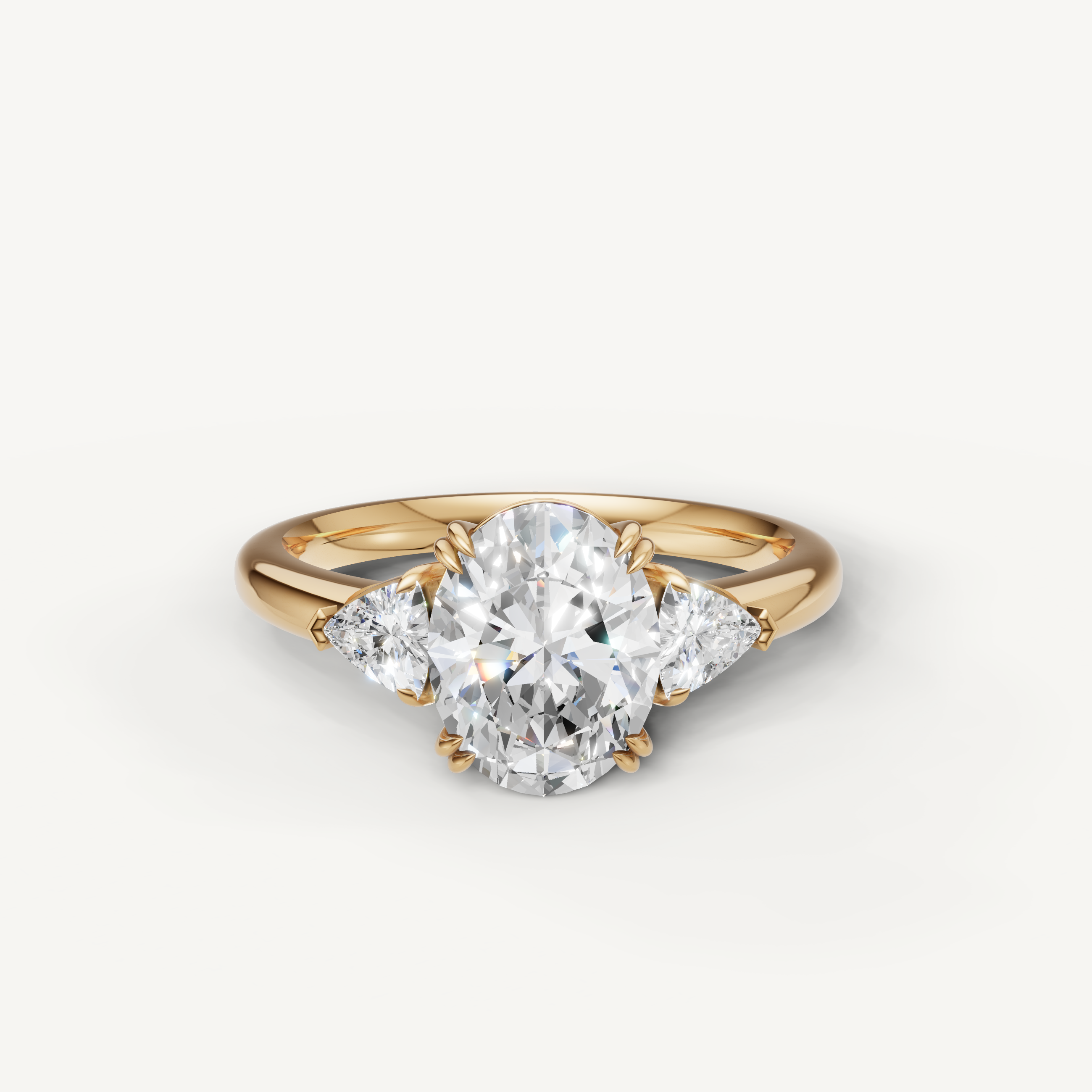 oval cut lab grown diamond engagement ring with trillion side stones in 14k yellow gold