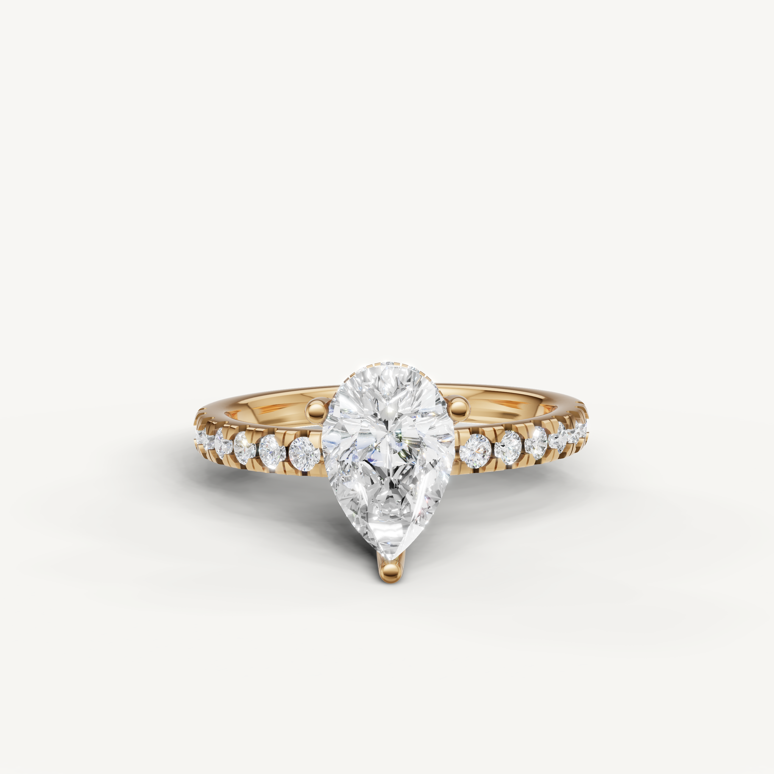 pear cut lab grown diamond engagement ring with pavé band yellow gold