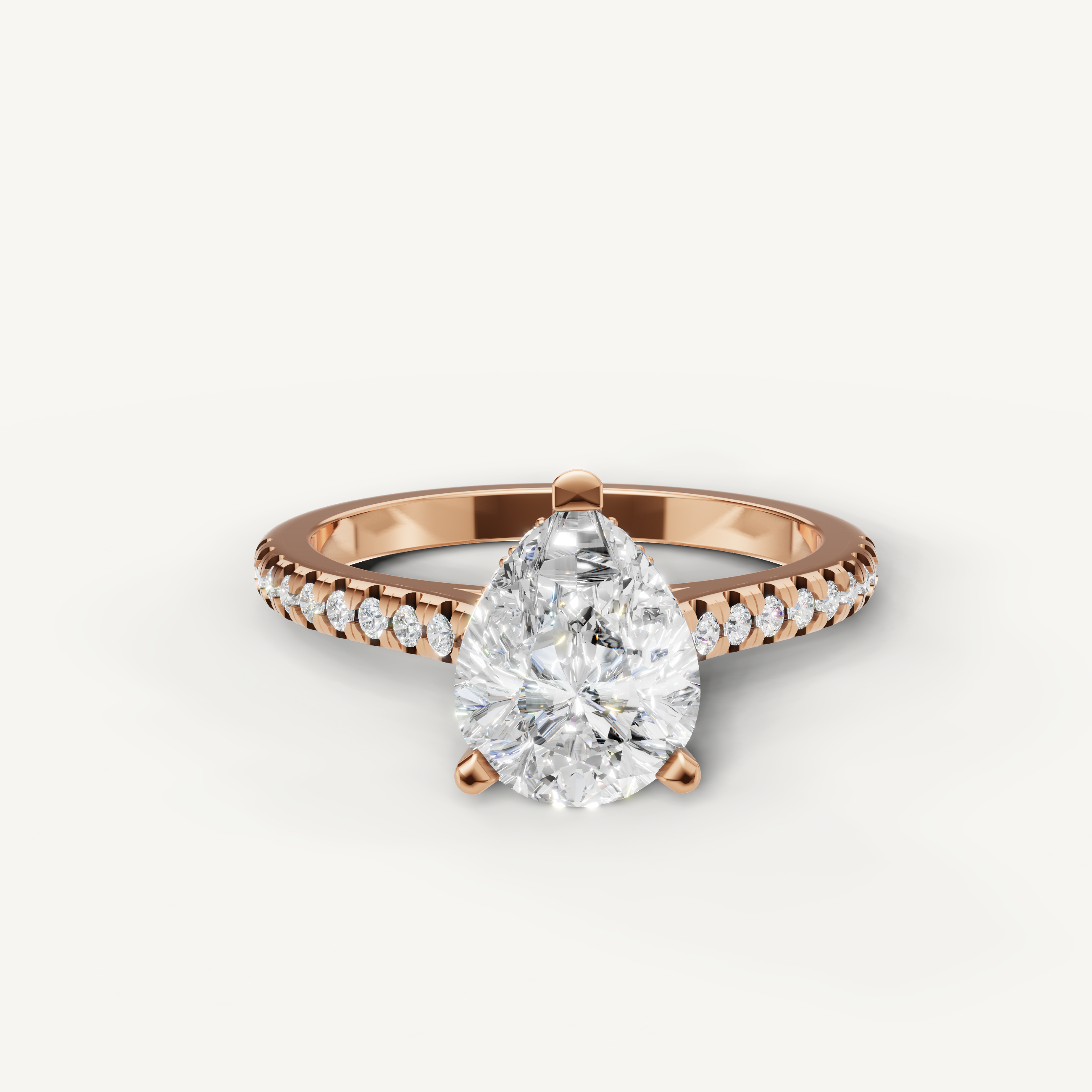 Pear cut lab grown diamond engagement ring with pavé band in 14K rose gold by Raul Diamonds