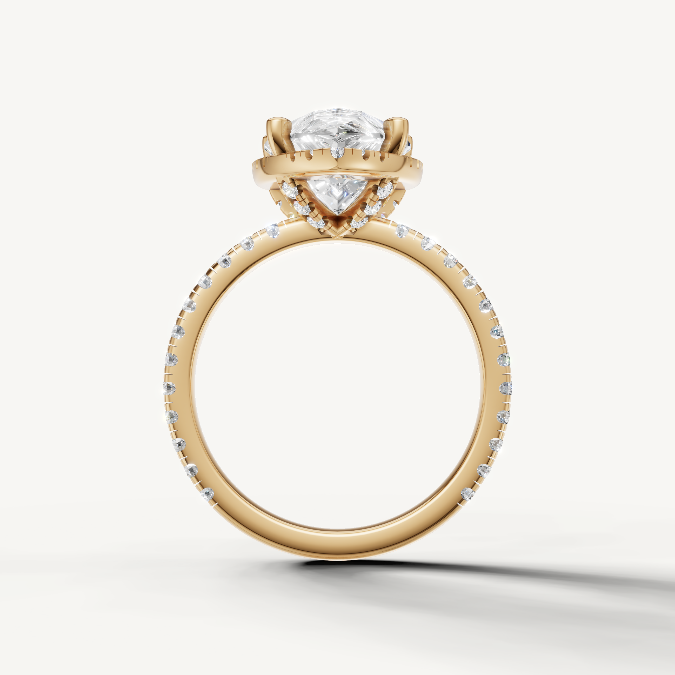 Pear shaped diamond ring with pavé band and hidden halo yellow gold timeless design