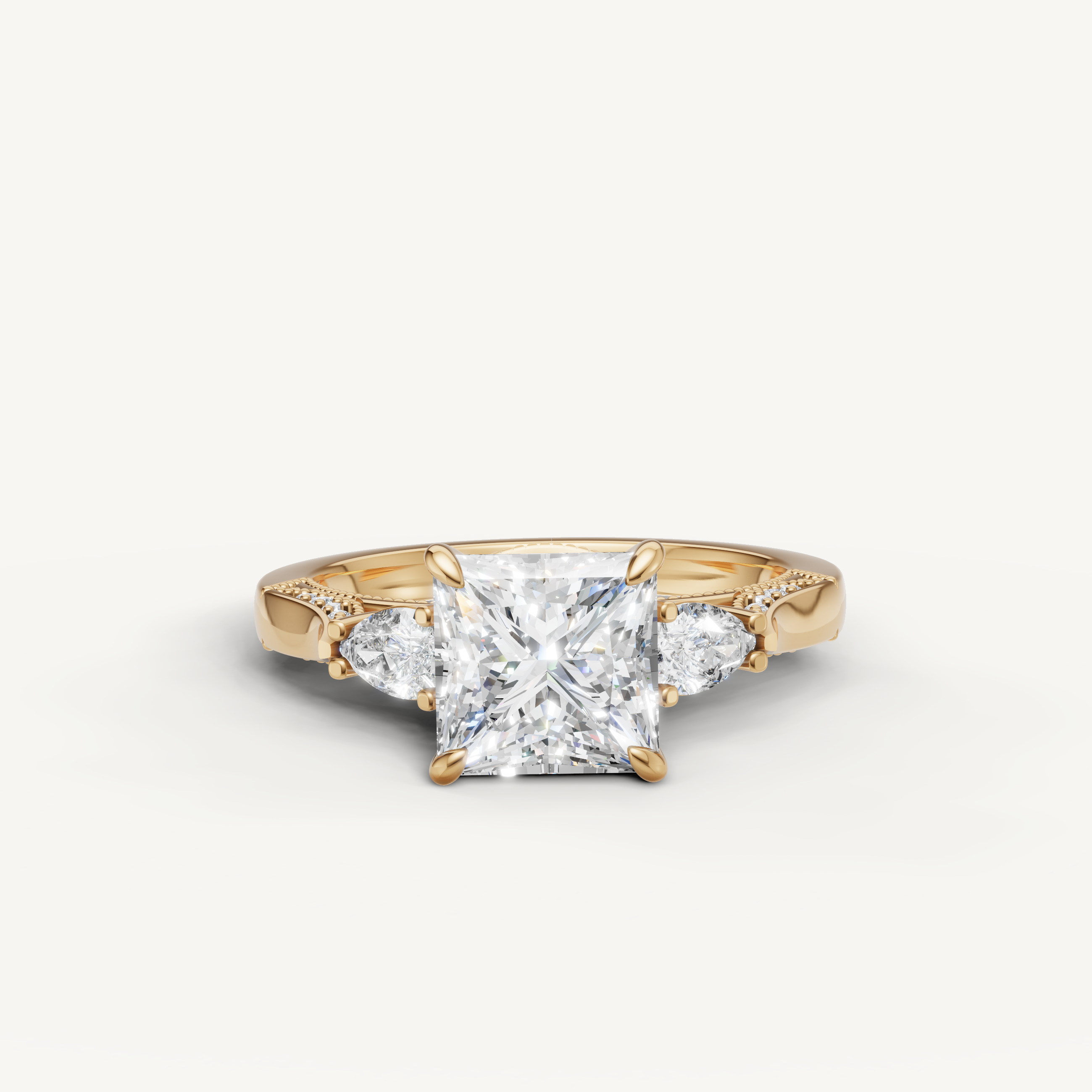 Princess cut lab grown diamond three stone ring with pear side stones yellow gold engagement ring