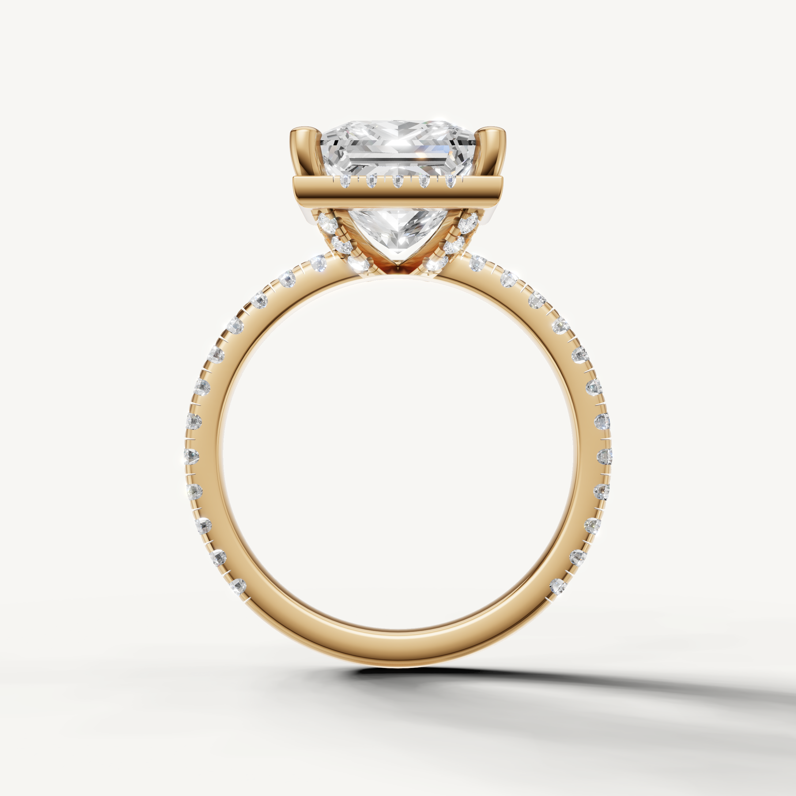 Princess shape diamond engagement ring with pavé band and hidden halo yellow gold