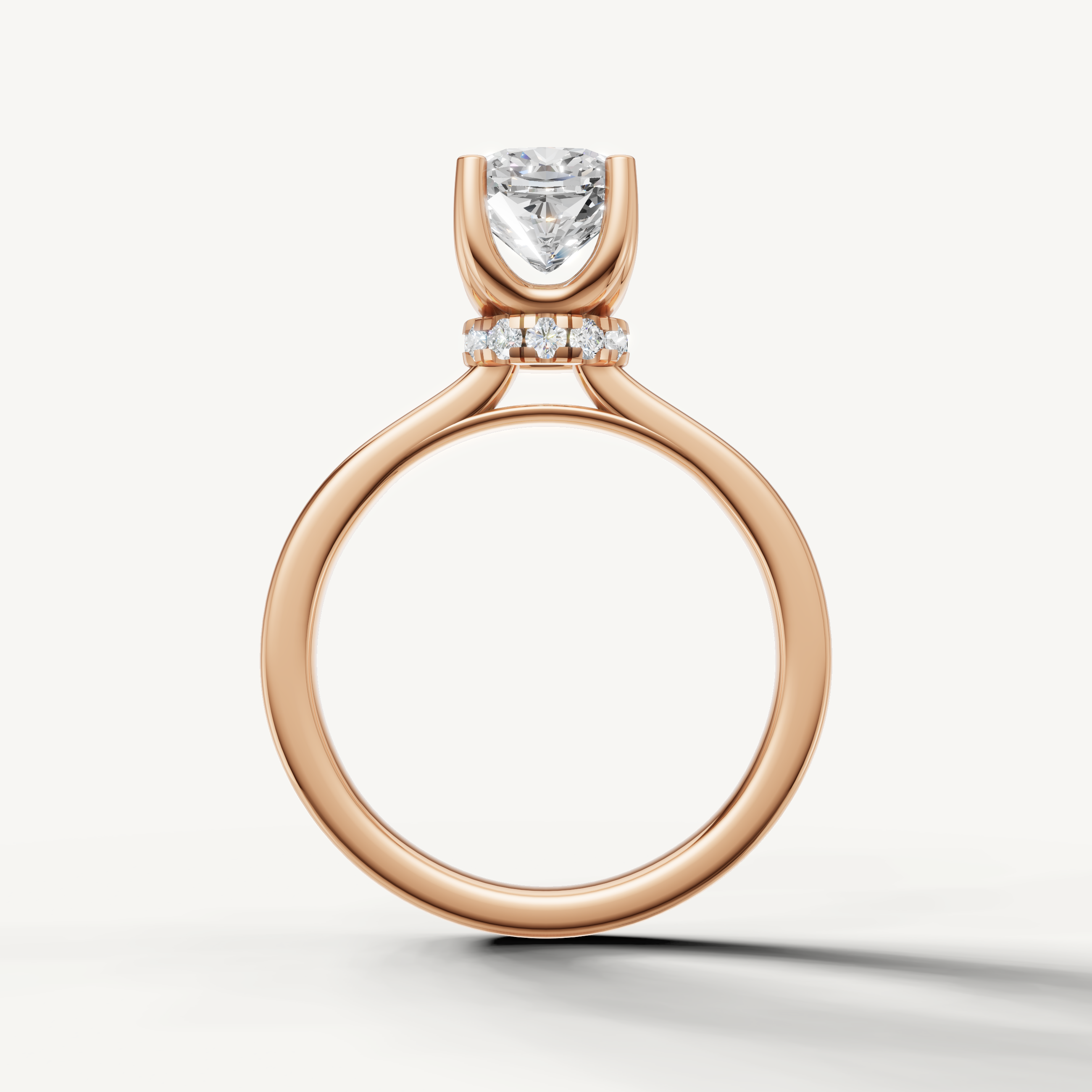 A refined engagement ring crafted in blushing rose gold, highlighting the elegant, vintage-inspired shape of a cushion-cut diamond.
