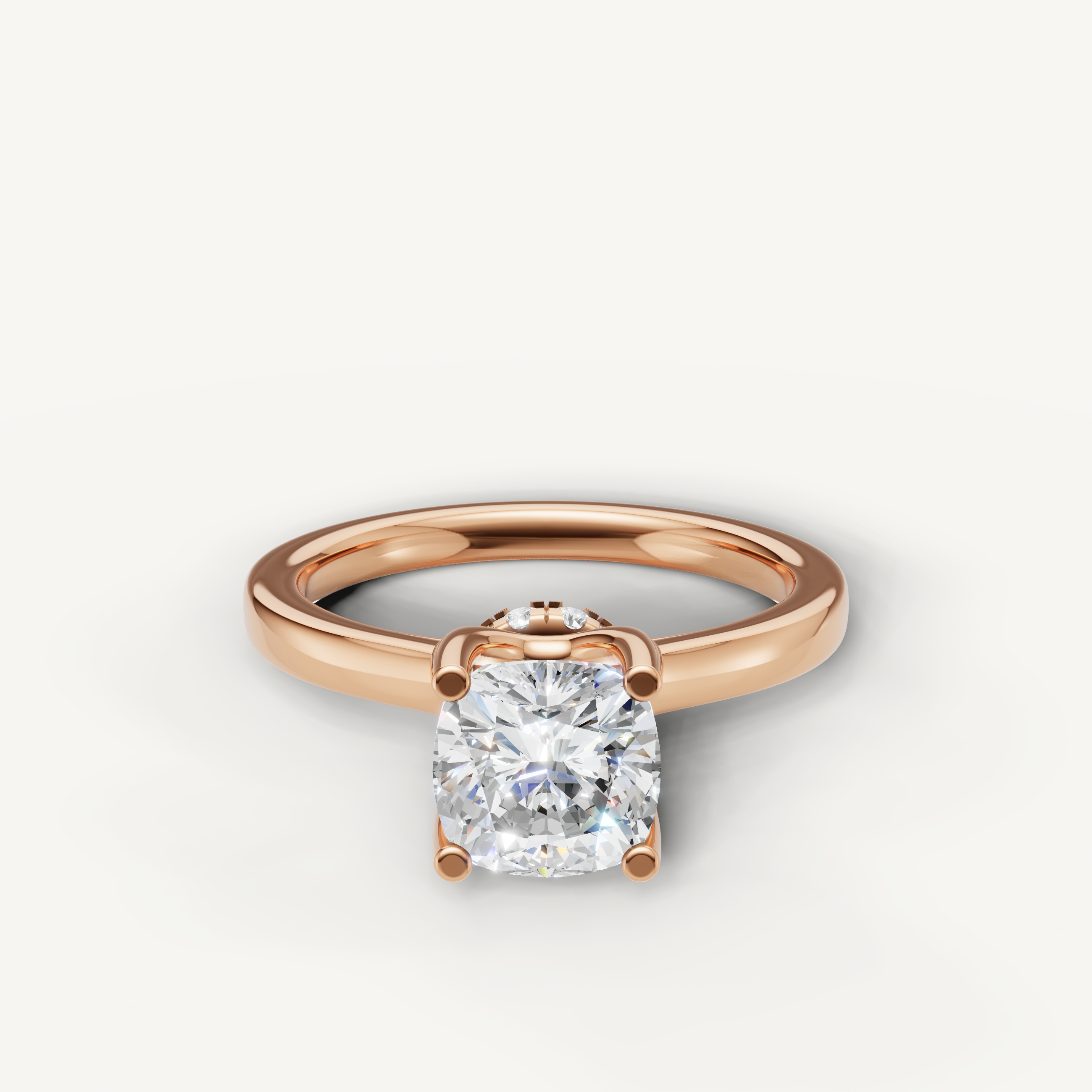 A romantic solitaire engagement ring in 14k rose gold, featuring a dazzling cushion-cut diamond held by four prongs.