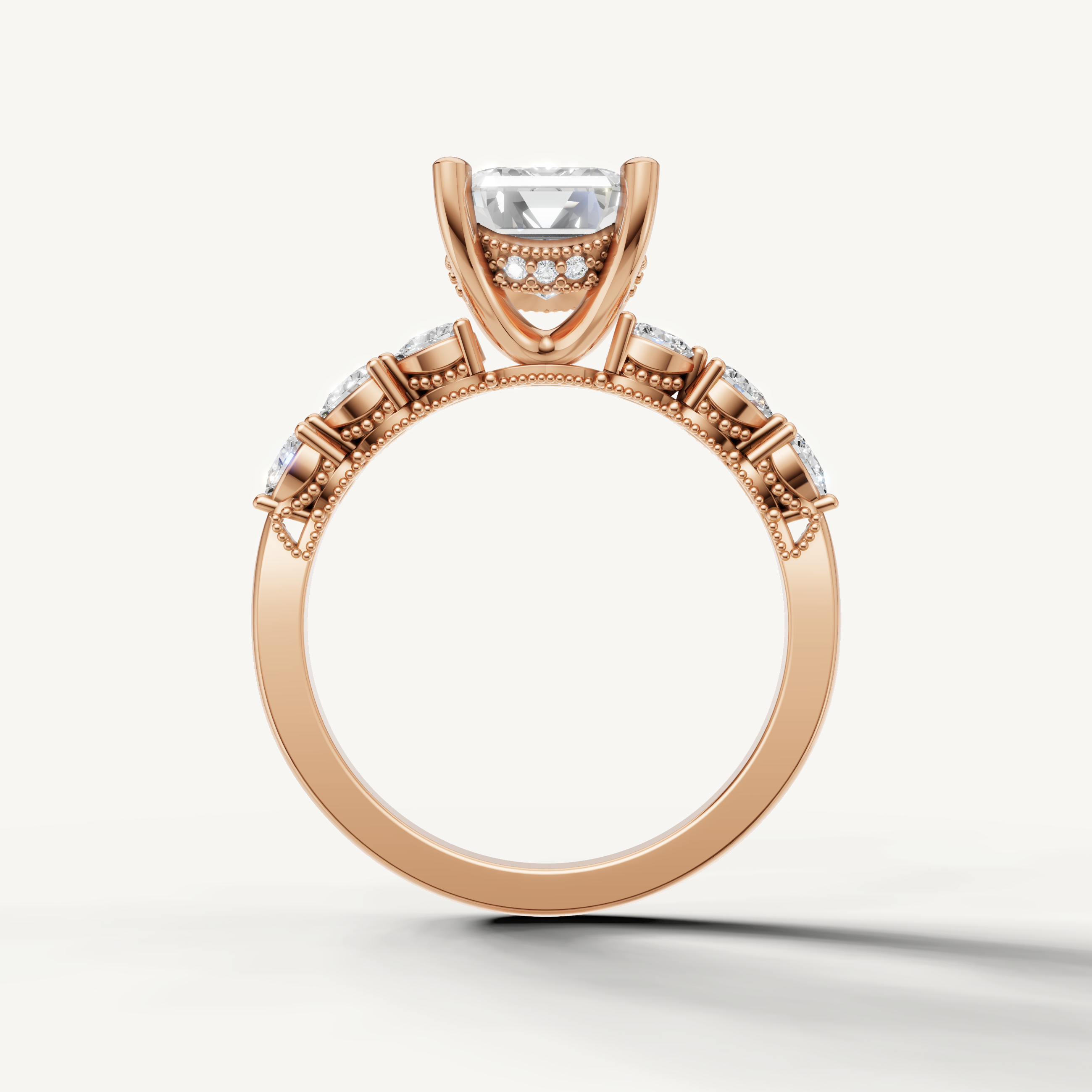 emerald diamond engagement ring with art deco marquise and baguette side stones rose gold