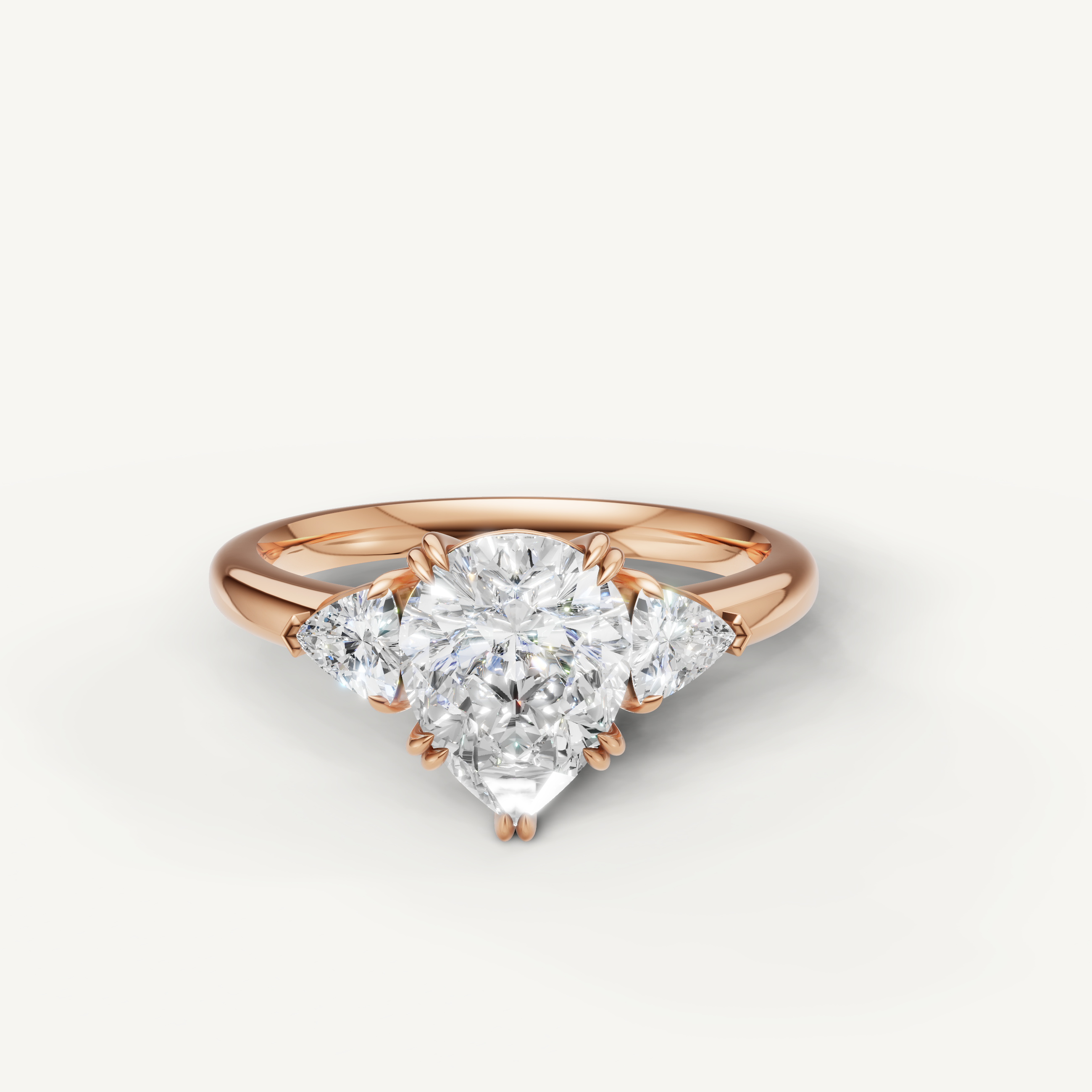 pear cut lab grown diamond engagement ring with trillion side stones in 14k rose gold