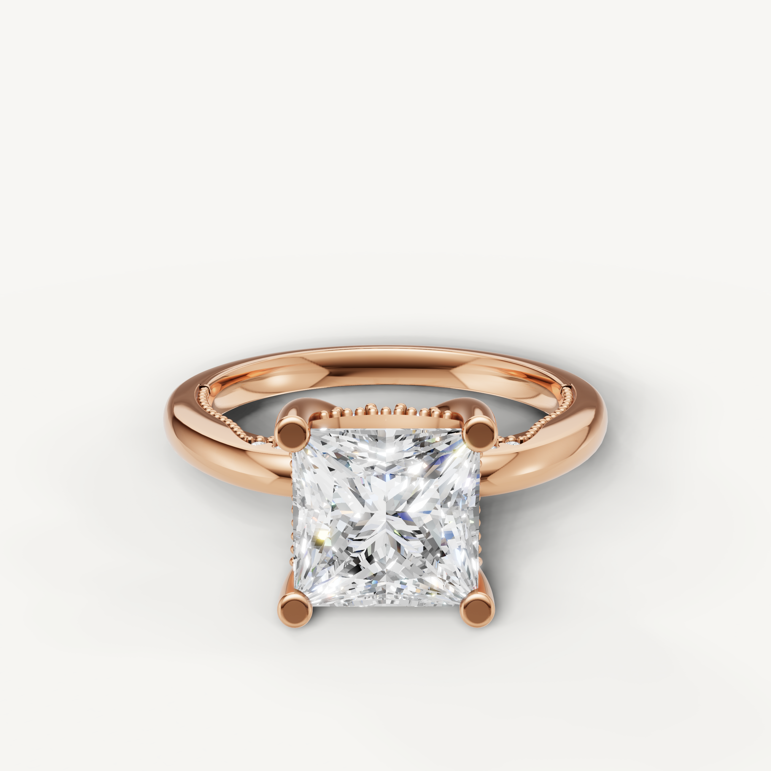 A romantic and modern engagement ring crafted in blushing 14k rose gold, featuring a striking princess-cut diamond held by delicate prongs.