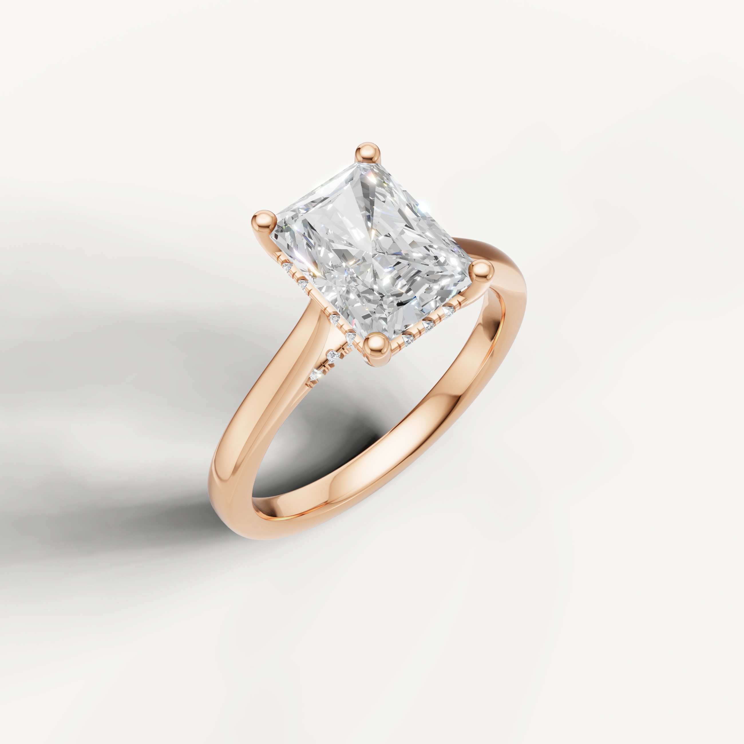Radiant-cut lab-grown diamond solitaire ring in rose gold with pavé hidden halo by Raul Diamonds
