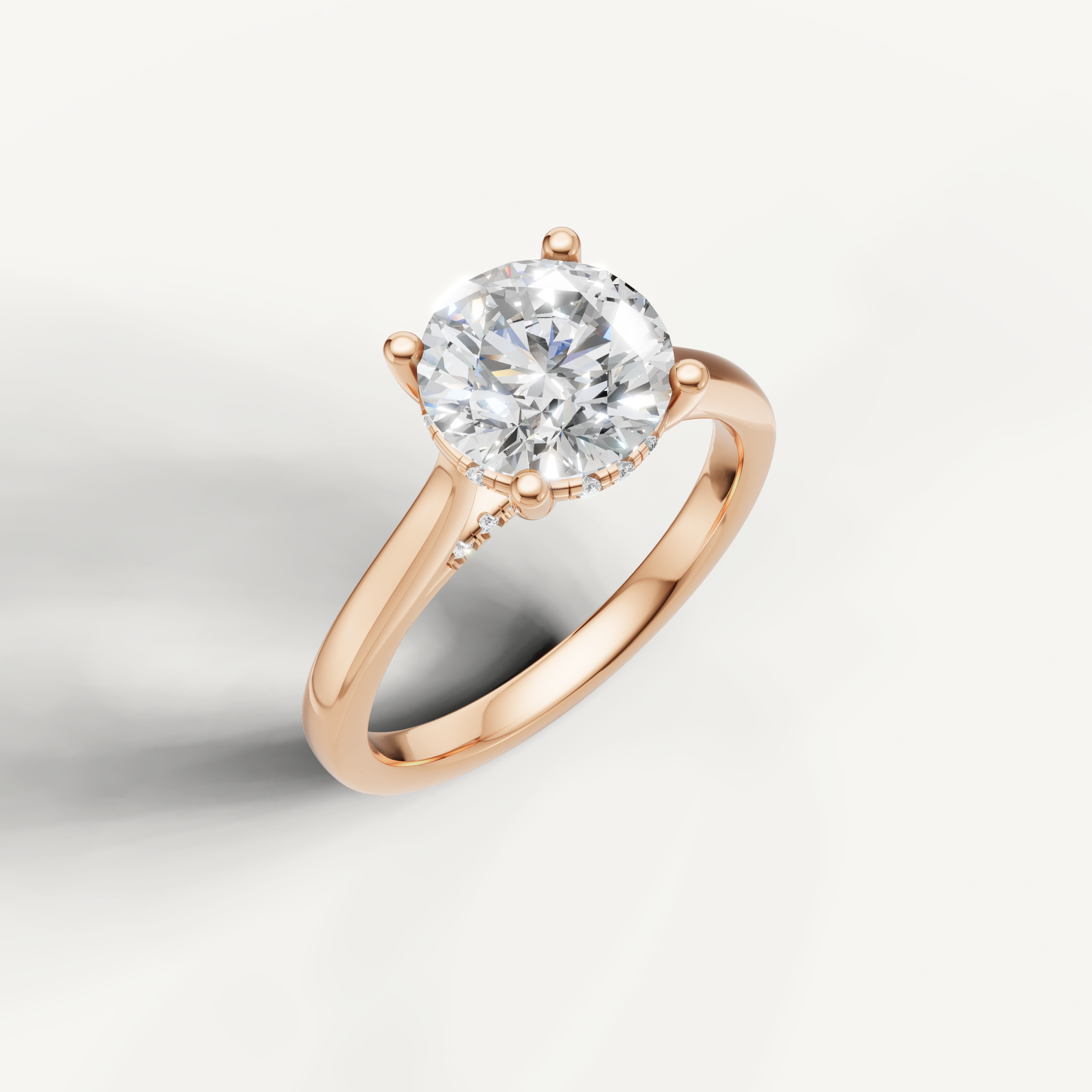 Round-cut lab-grown diamond solitaire ring in rose gold with pavé hidden halo by Raul Diamonds