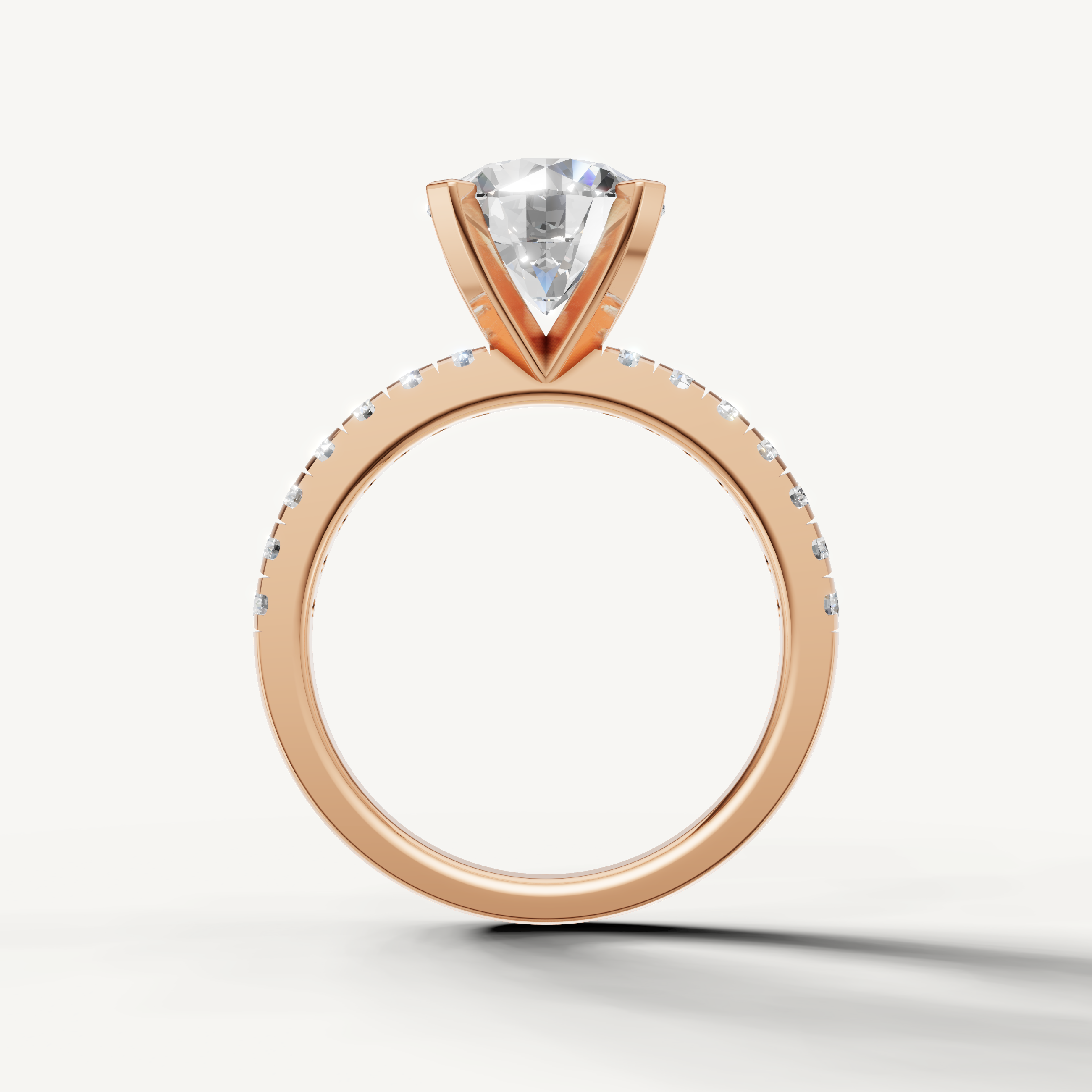 Rose gold round solitaire ring with brilliant center diamond and diamond band.