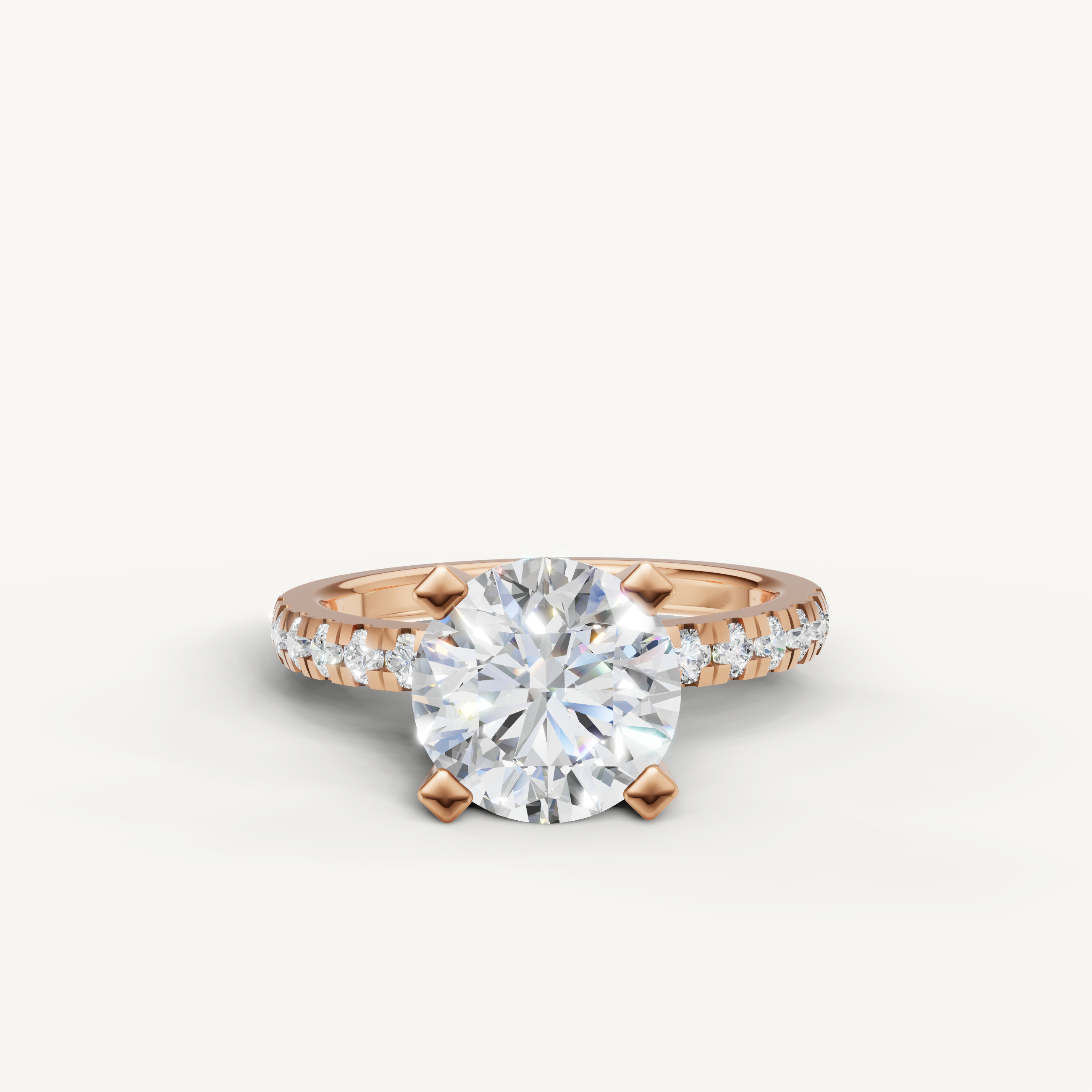 Rose gold round brilliant engagement ring with pavé band by Raul Diamonds.