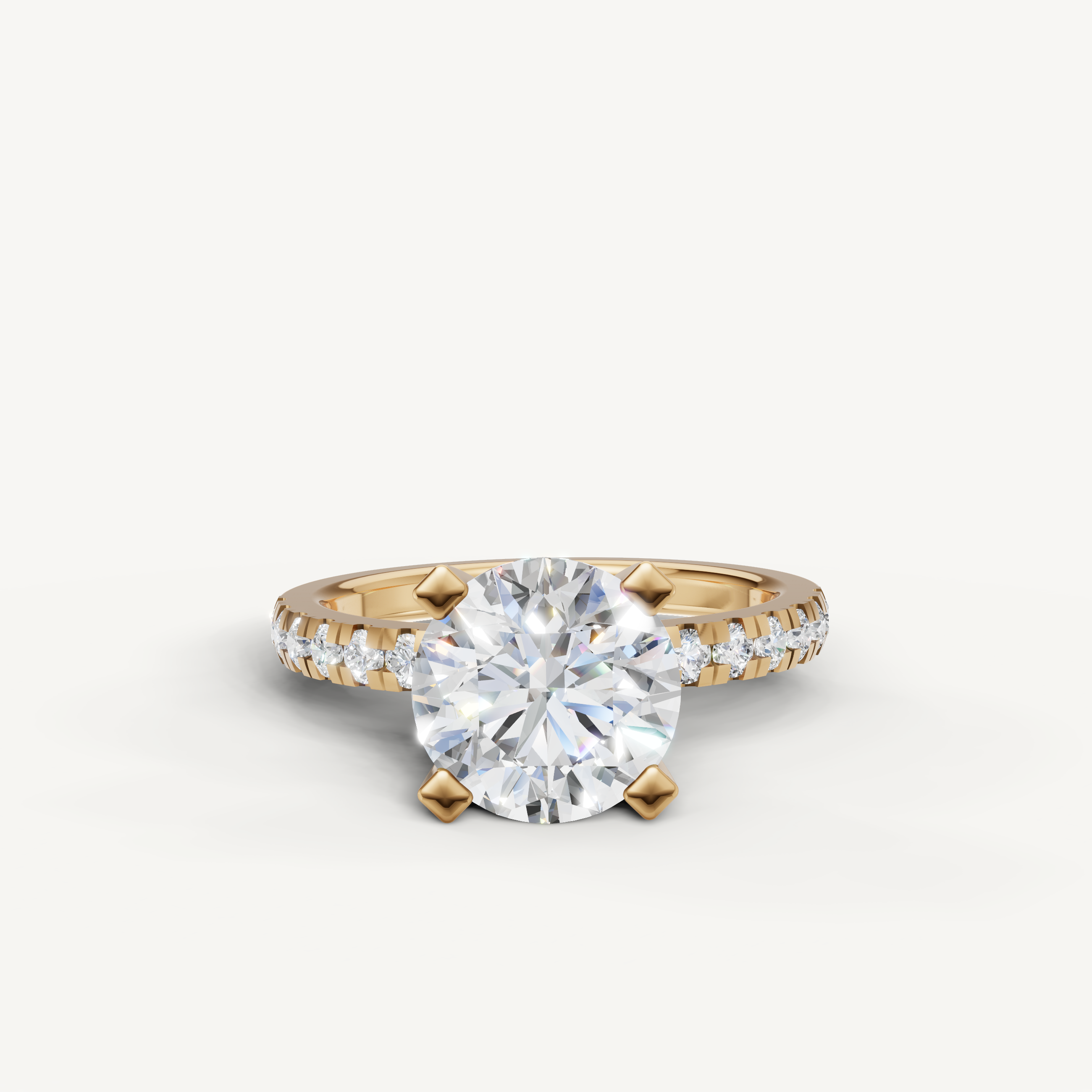Raul Diamonds round solitaire engagement ring with pavé diamond band in yellow gold.
