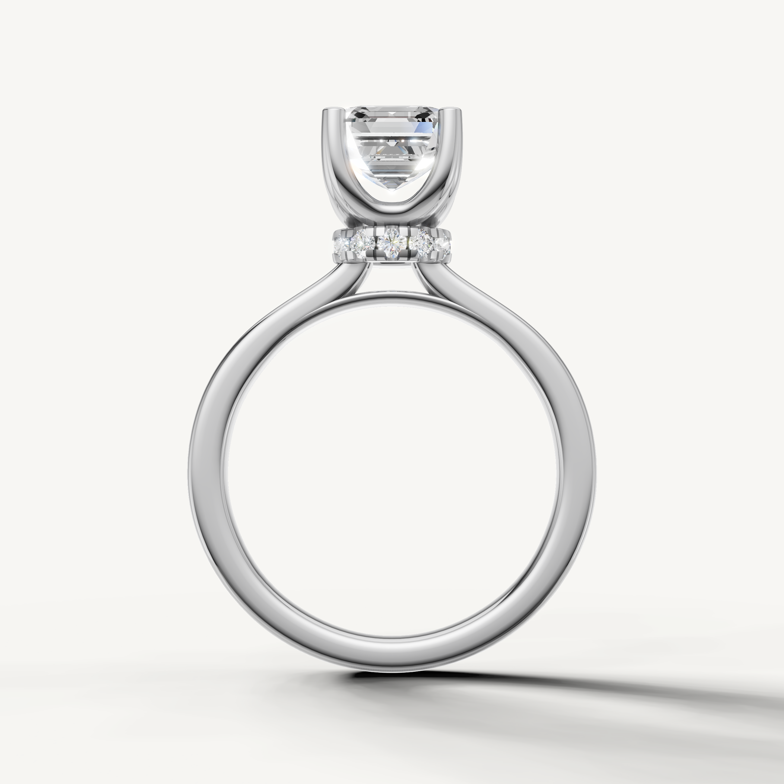 A luxury white gold engagement ring that maximizes the art-deco brilliance of a central Asscher-cut diamond against a cool, bright metal finish.