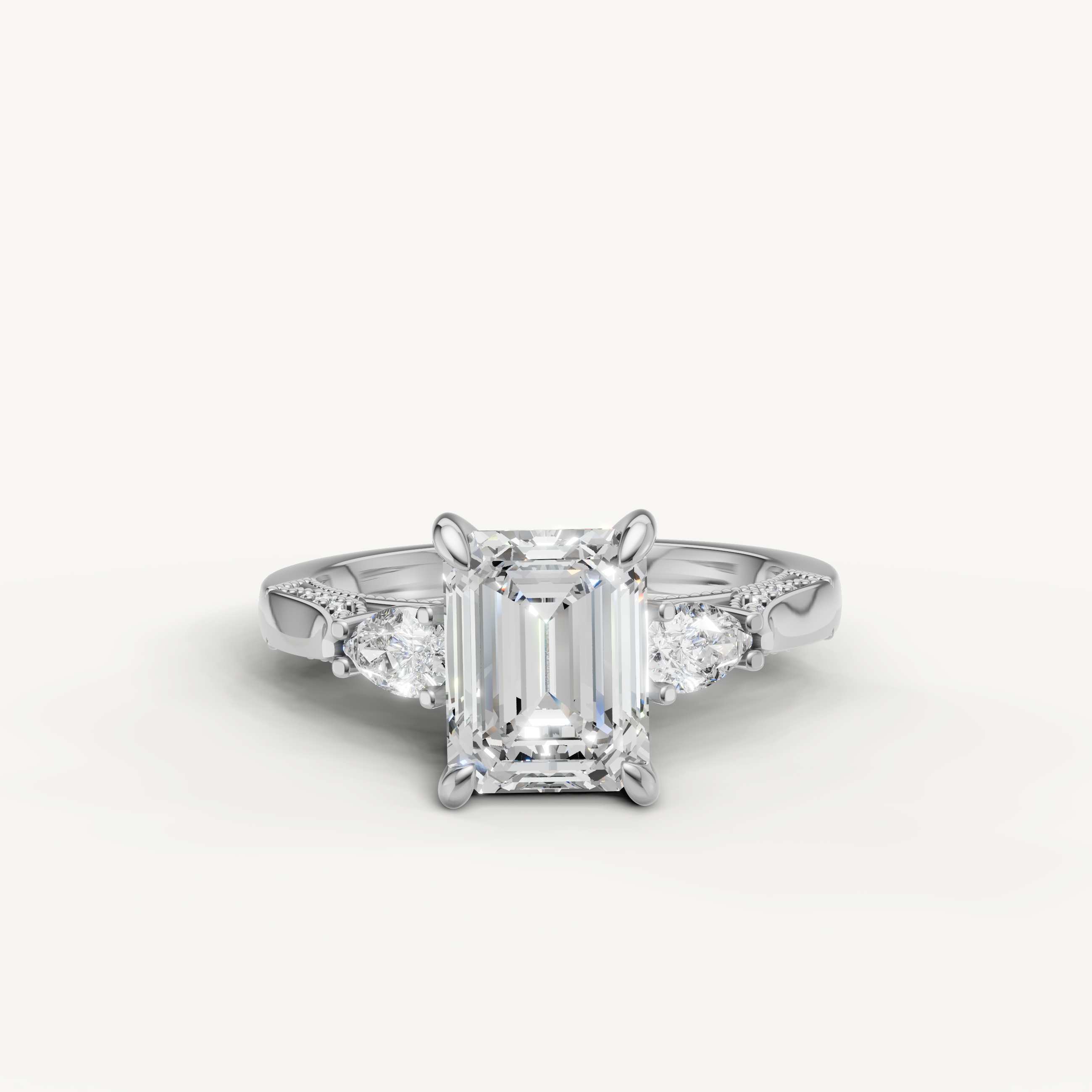 Emerald cut lab grown diamond three stone ring with pear side stones white gold engagement ring