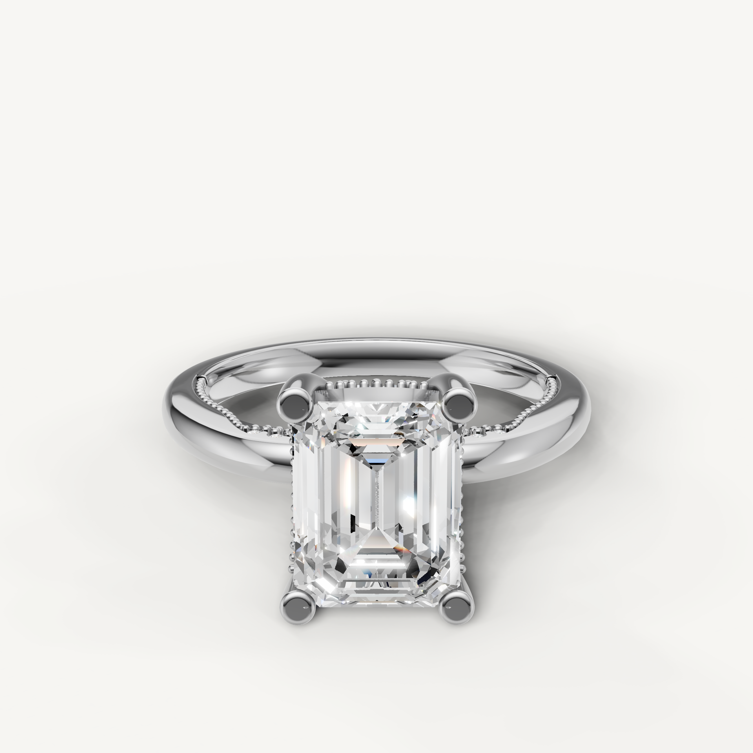 A classic solitaire engagement ring in bright, polished white gold or platinum, featuring a stunning, high-clarity emerald-cut diamond.