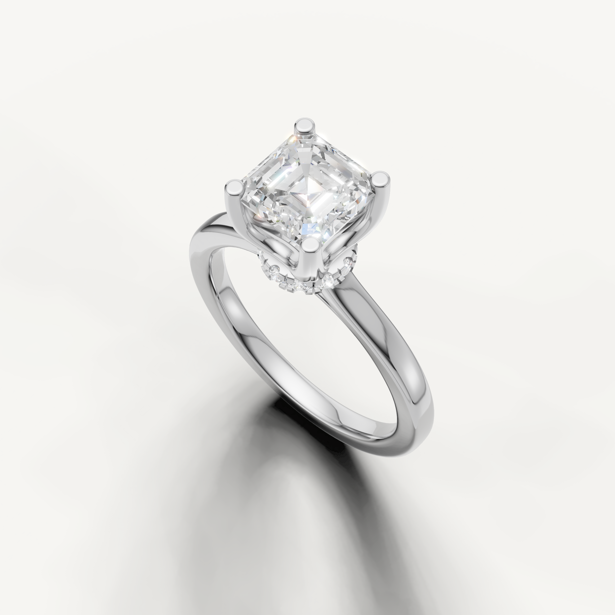 A high-polish white metal solitaire ring showcasing the sophisticated, sharp lines of a large square Asscher-cut diamond.