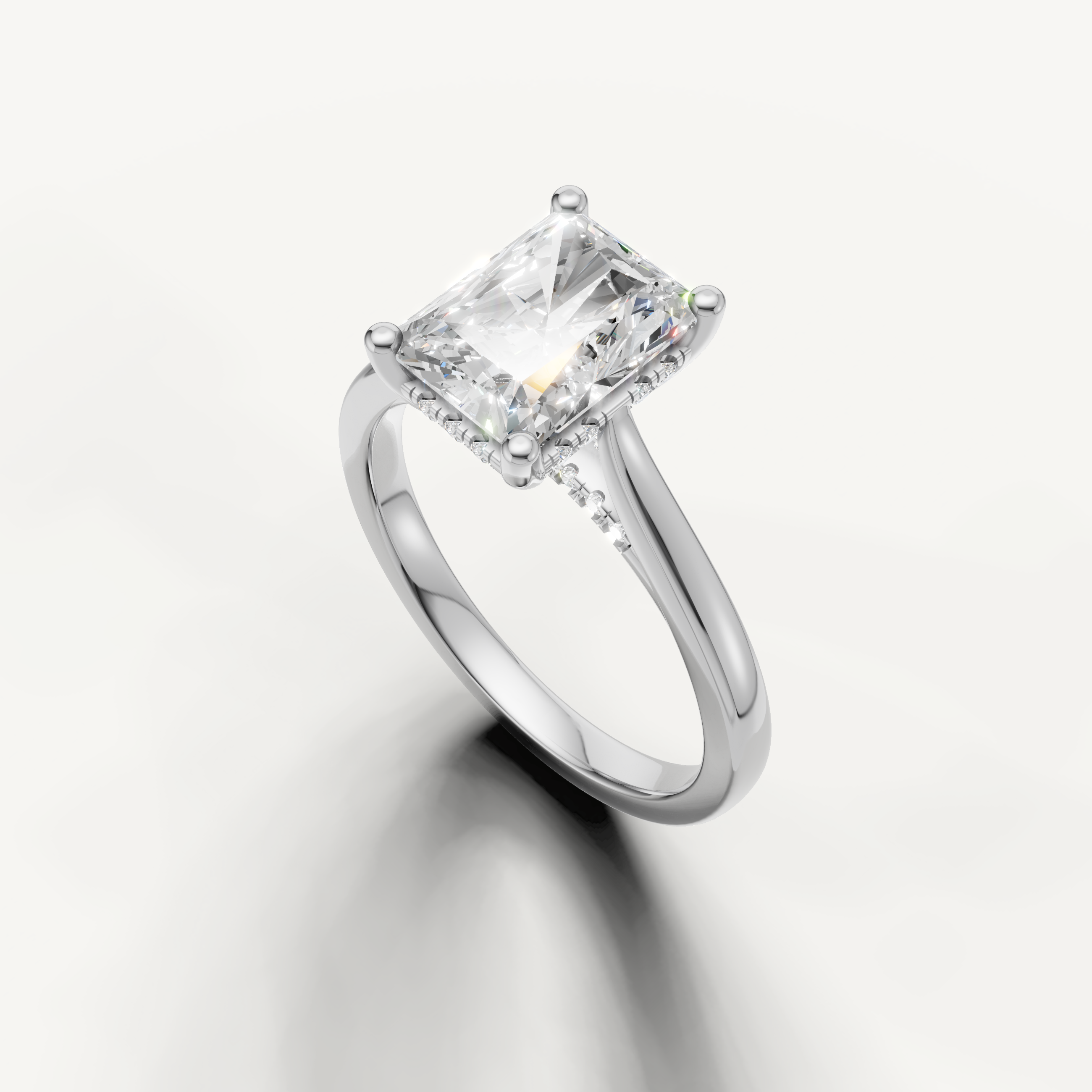 Side profile white gold radiant-shaped lab diamond engagement ring with hidden halo