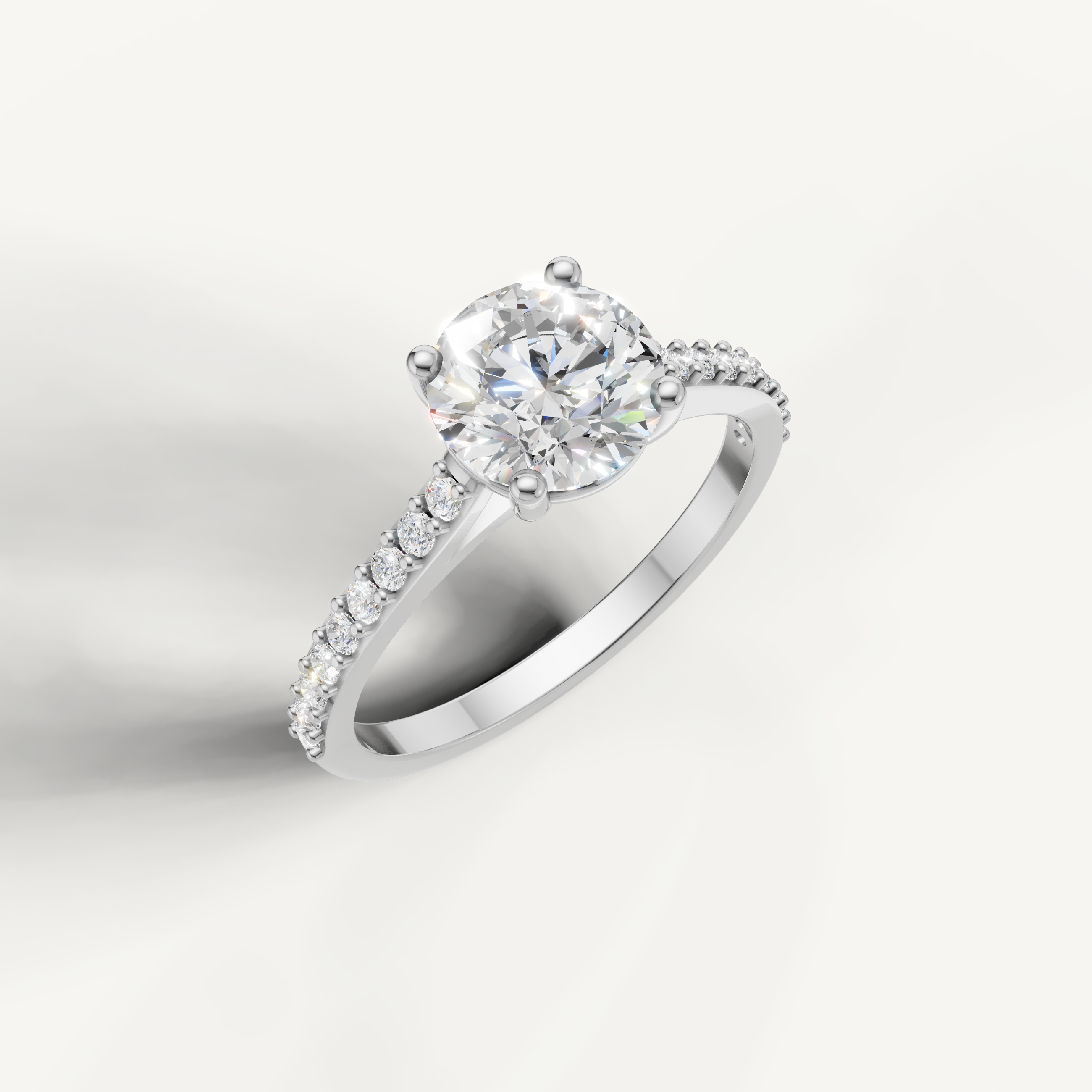 Modern white gold round cut diamond ring with elegant pavé setting.
