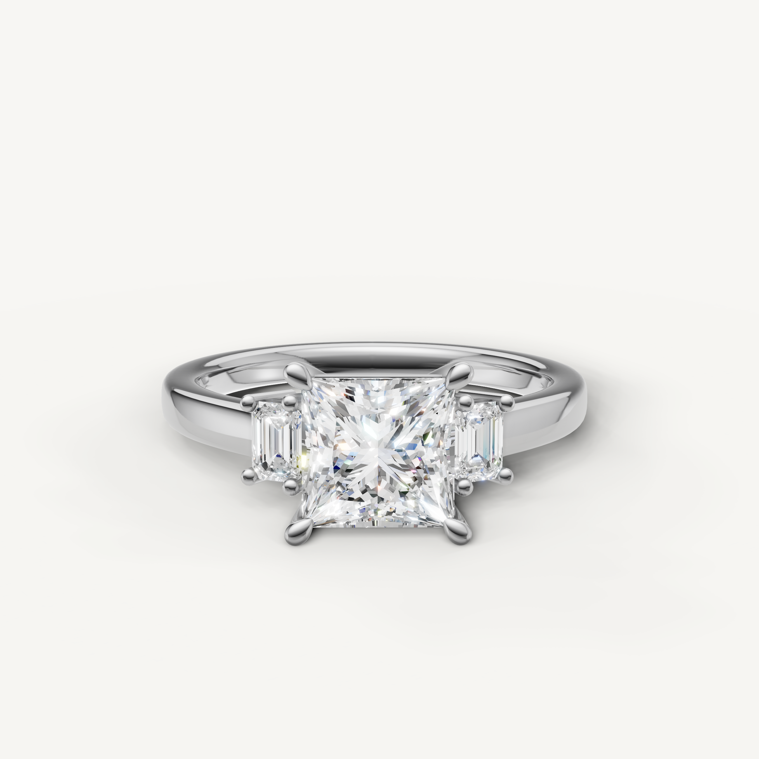 Princess cut lab grown diamond three stone engagement ring in 14K white gold with emerald cut side stones