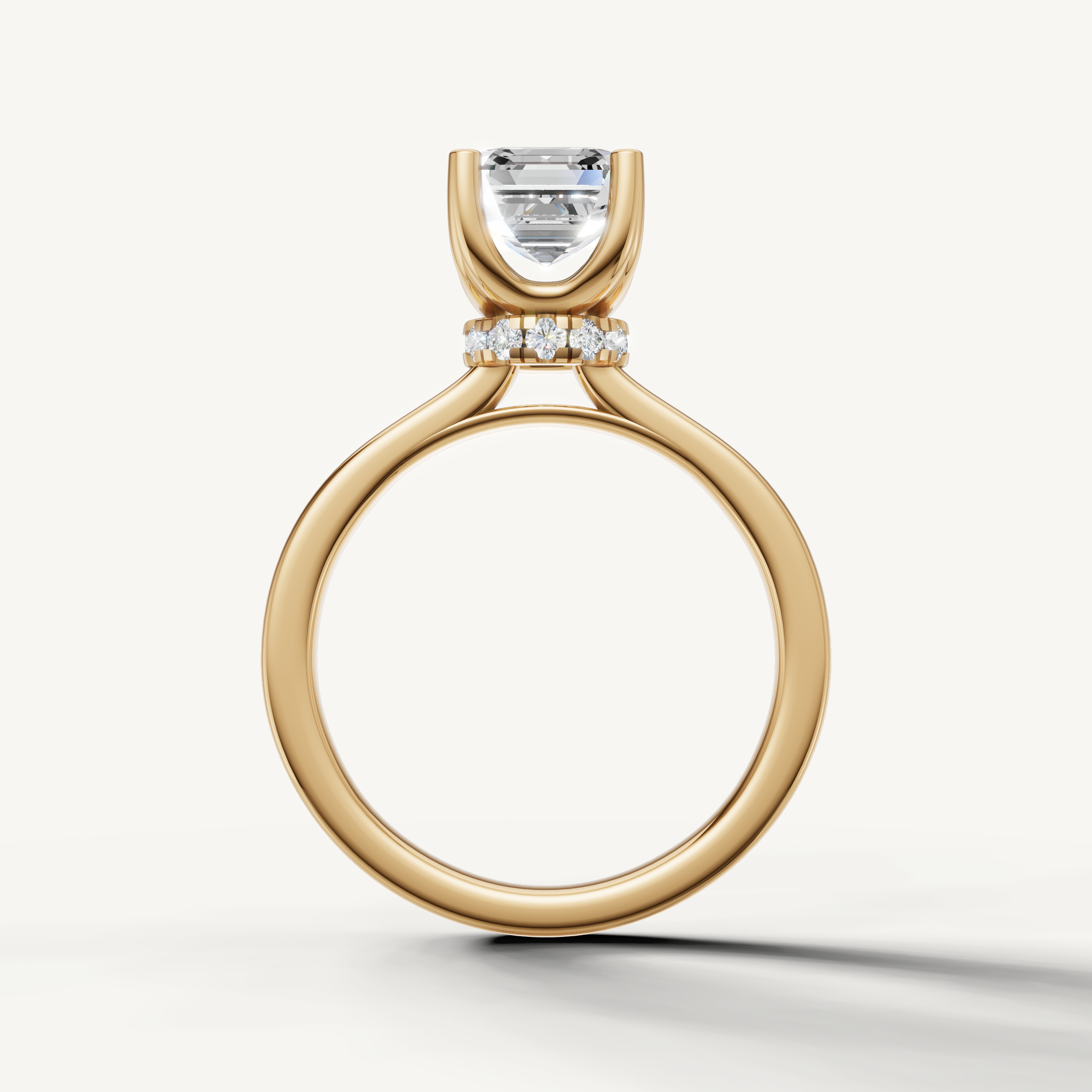 A sleek, contemporary yellow gold solitaire ring that focuses attention on the architectural, multifaceted Asscher-cut diamond.