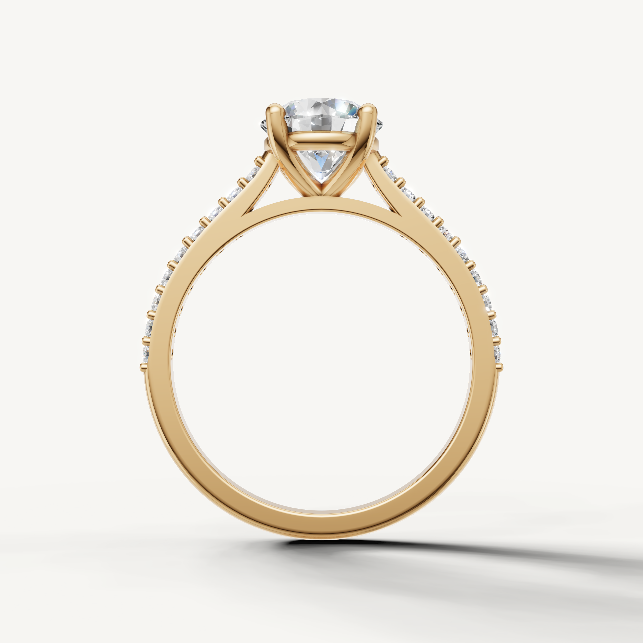 Elegant round solitaire ring from Raul Diamonds with sparkling side diamonds.