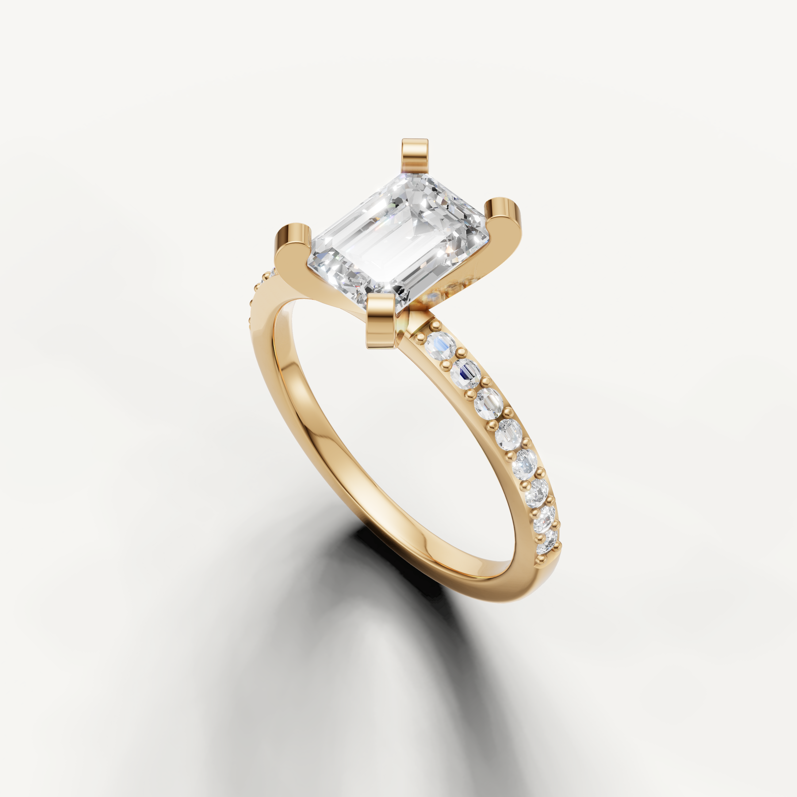 Elongated emerald cut diamond ring in yellow gold with micro pavé diamonds