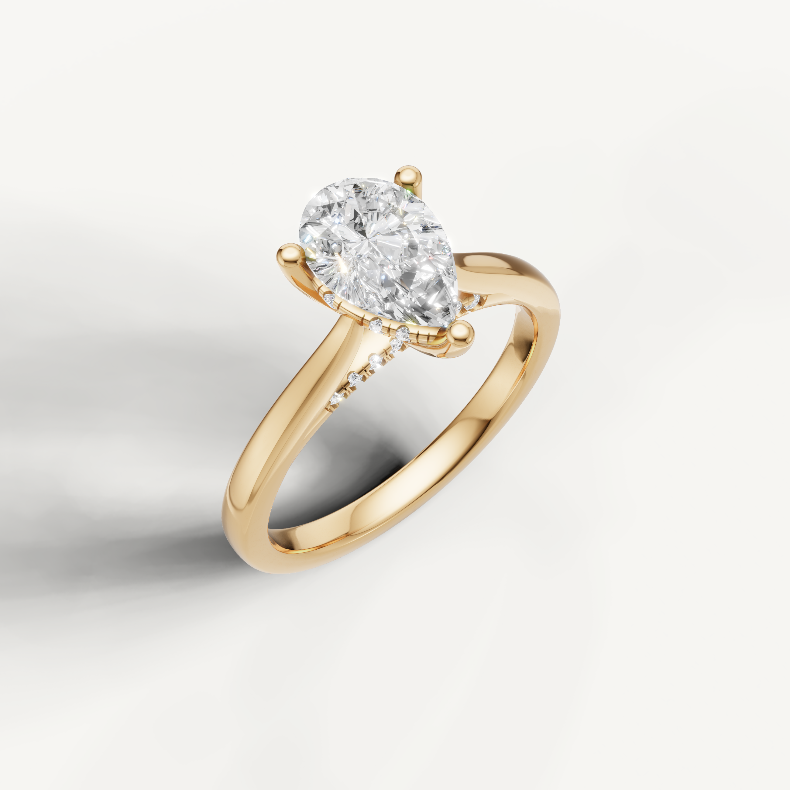 Pear-cut lab-grown diamond solitaire ring in yellow gold with pavé hidden halo detailing