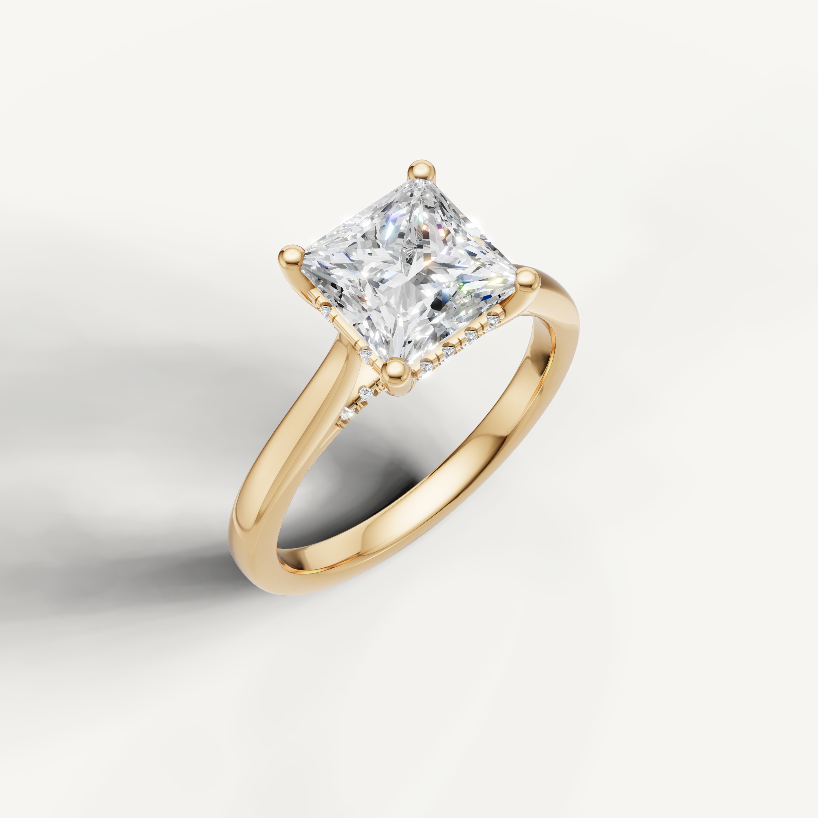 Princess-cut lab-grown diamond solitaire ring in yellow gold with pavé hidden halo detailing